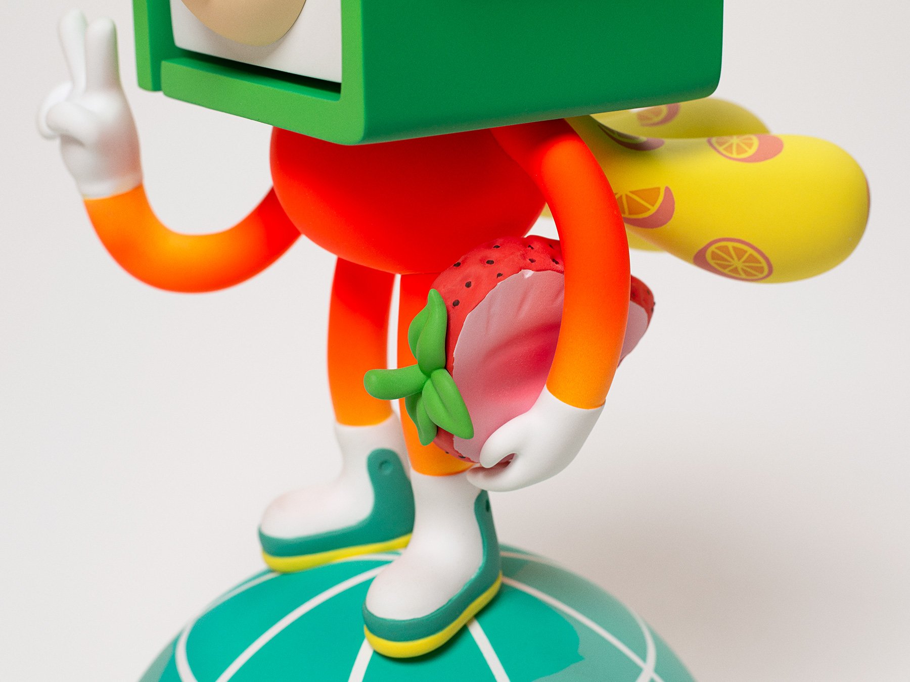 Detail photo of the character figurine holding a soccer-ball-sized strawberry for Taiwanese brand DaYung's.