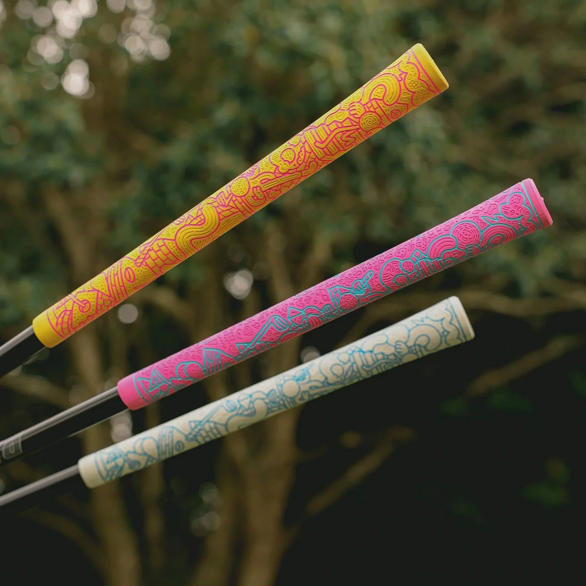 Close-up shot of Brosmind's custom engraved golf club grips on a green golf course, created for RIPIT Grips.