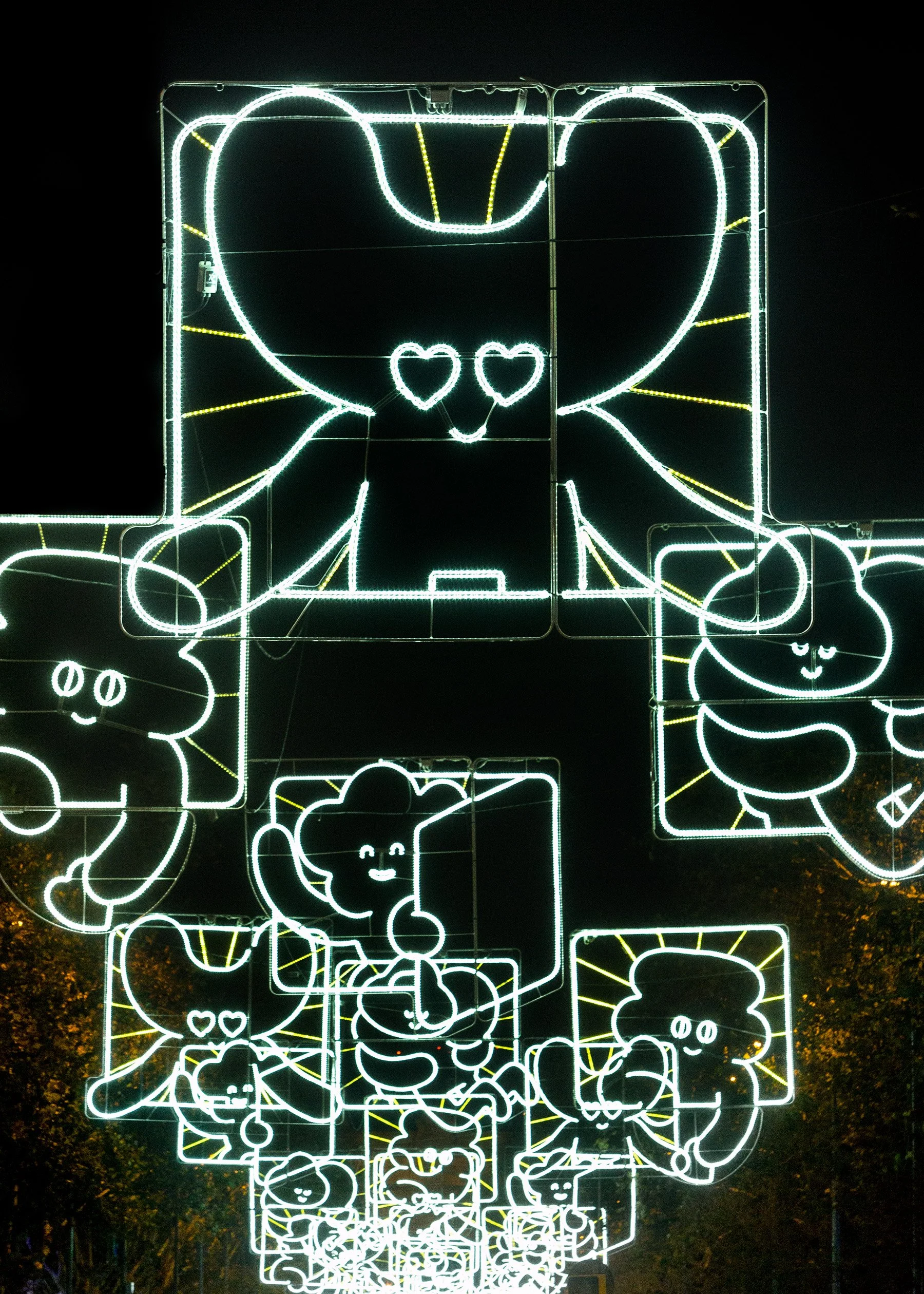 Night view of overlapping Kawaii character lights creating a dense, glowing festive atmosphere.