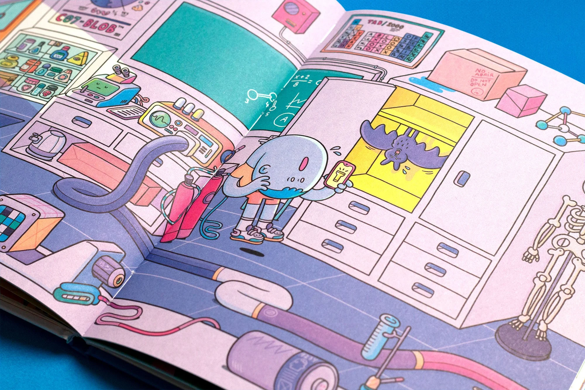 Close-up photograph of an open page spread from the children's book showing a colorful illustration of a boy discovering a bat in a school lab.