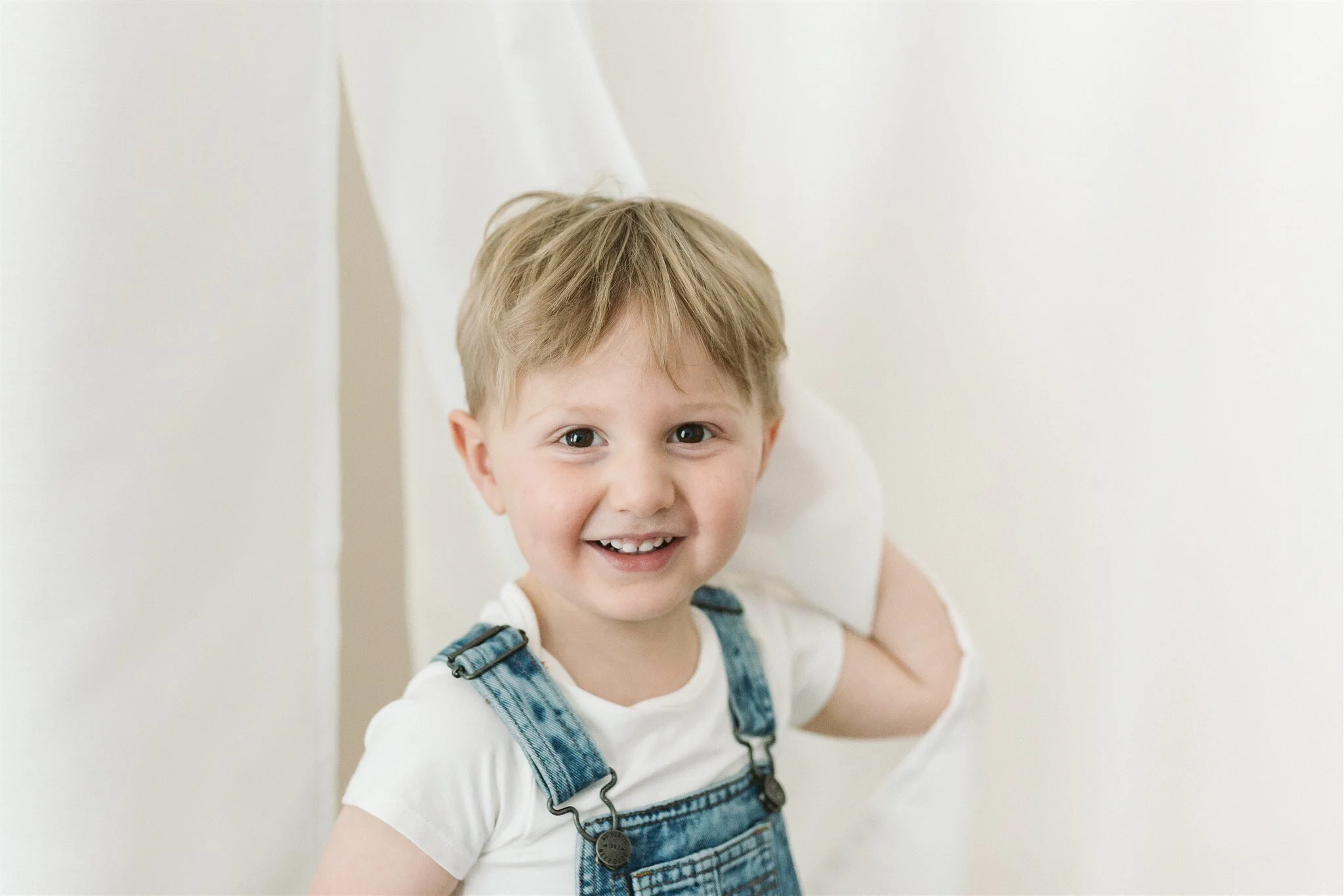   I really like the one of Cameron playing with the white drapes because this is just so him, the cheeky little guy.  
