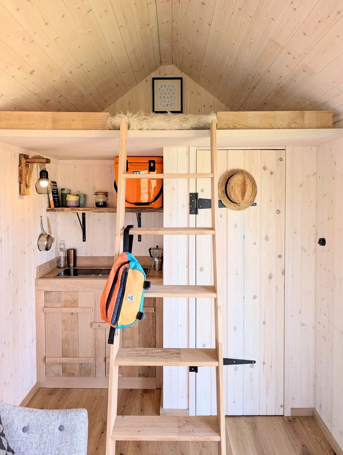 Olivers-Huts-go-cabin-interior-wood-ladder.jpg