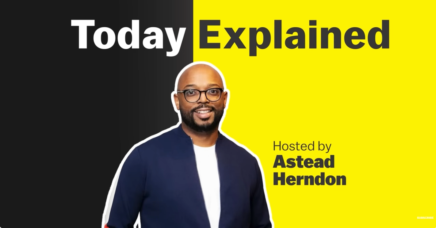 A promotional graphic for a show called 'Today Explained' hosted by Astead Herndon, featuring a smiling man with glasses and a beard, wearing a navy jacket over a white shirt, against a background divided into black and yellow sections.