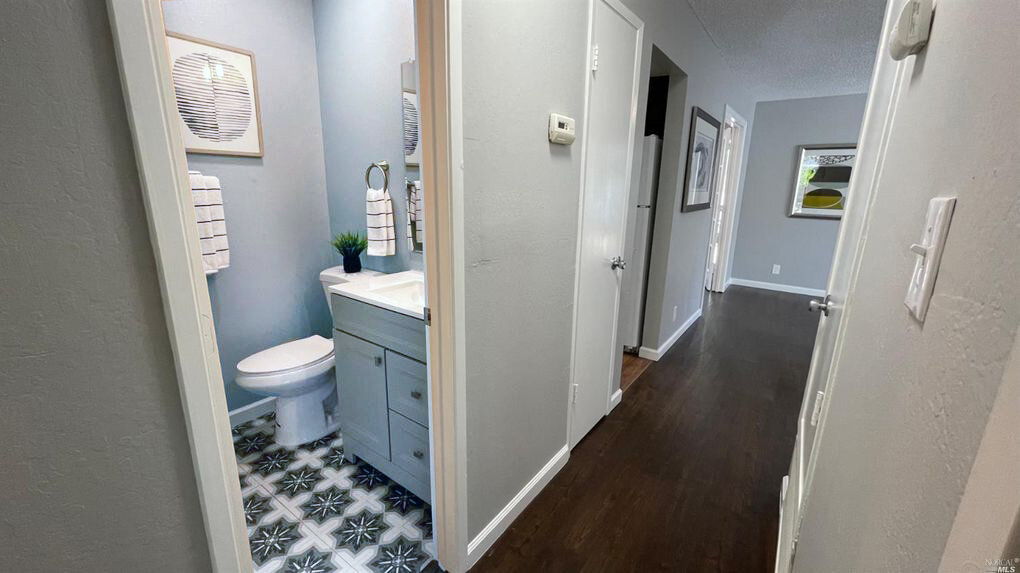 Make an old bathroom new again in a day. painted walls, linoleum floor tiles, new linens, modern artwork