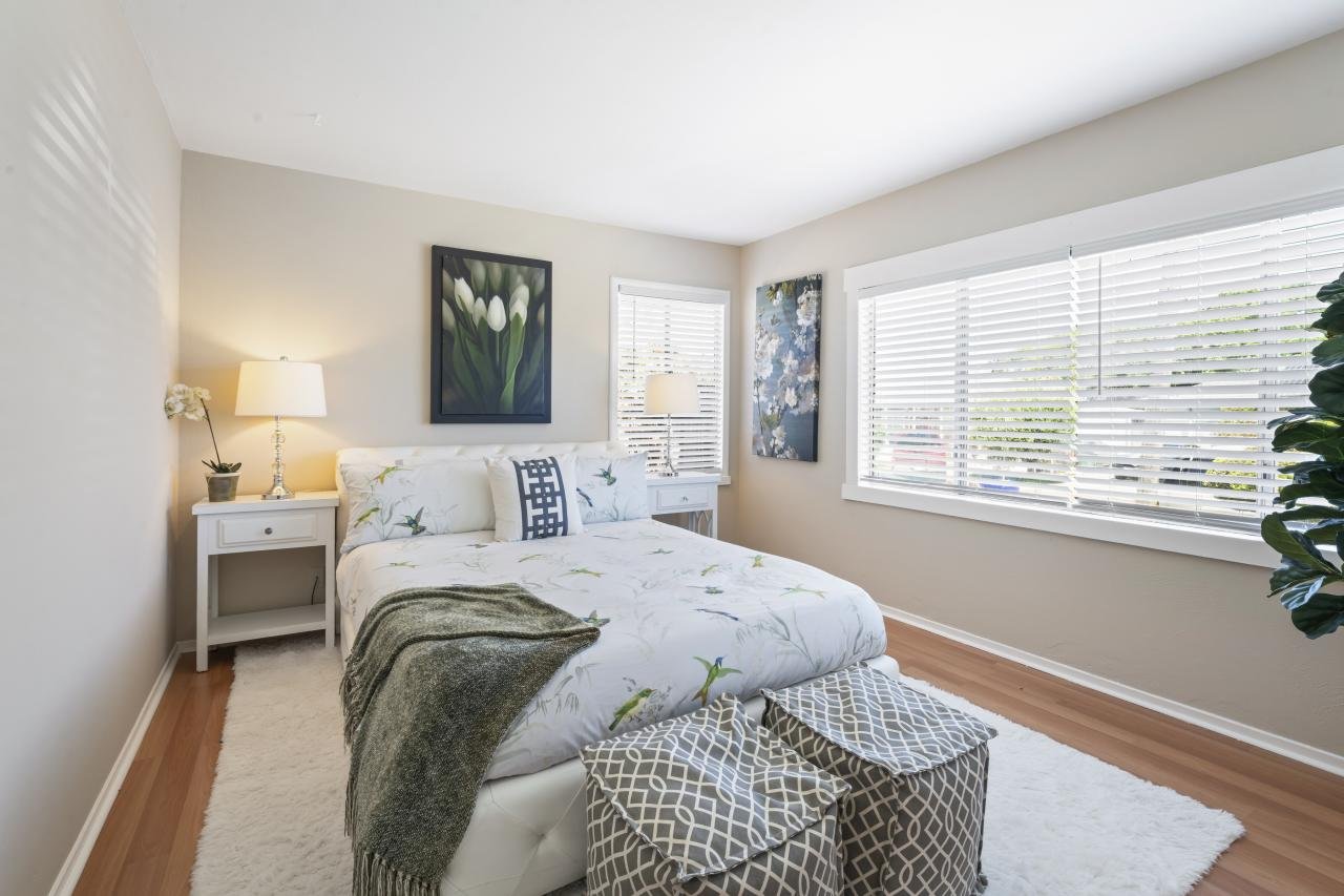 Staged to sell bedroom with big picture window. Property presentation by Style it Staging