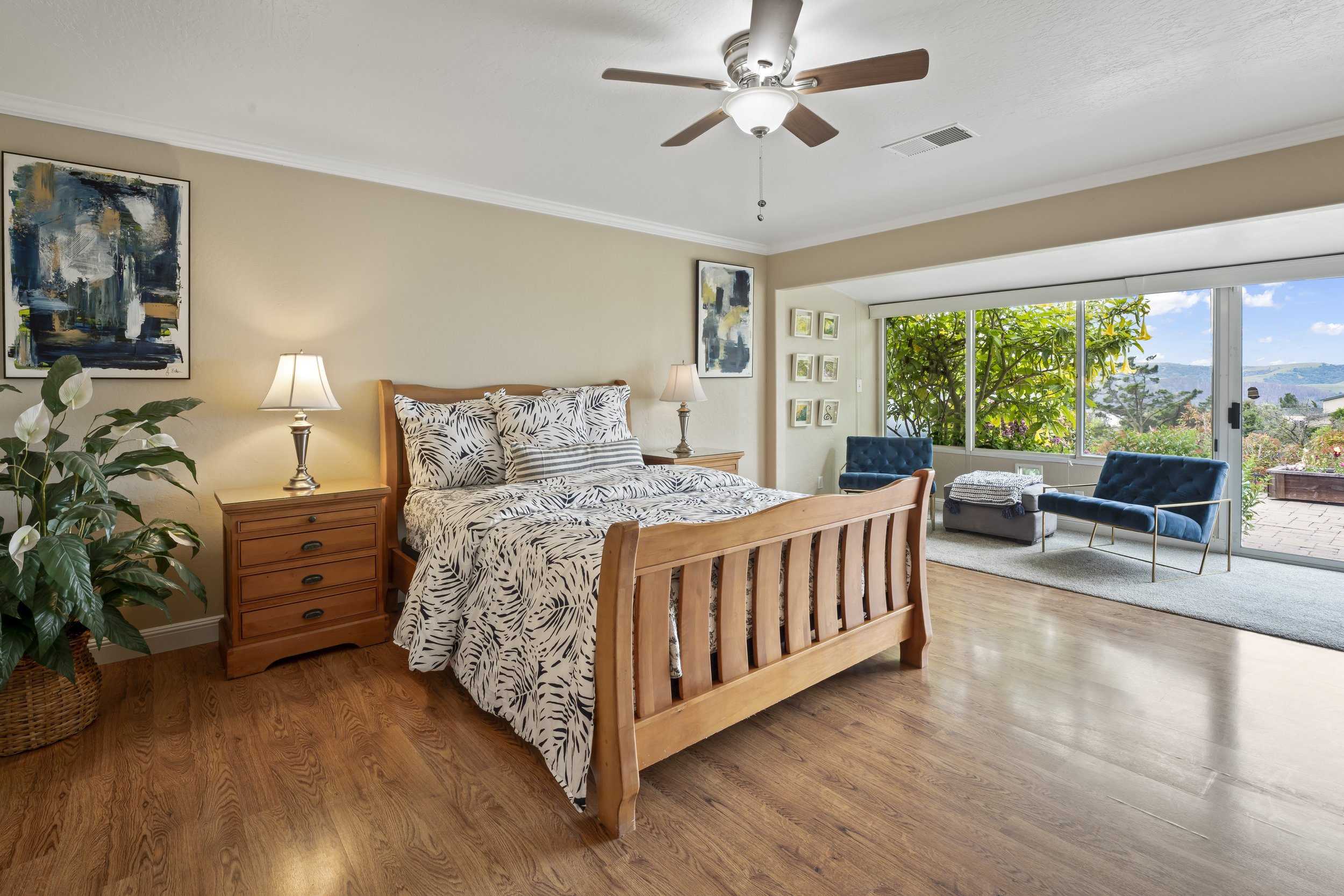 After staging furniture was removed and only key pieces were left including a seating area a queen sized bed and night stand and a large plant. 