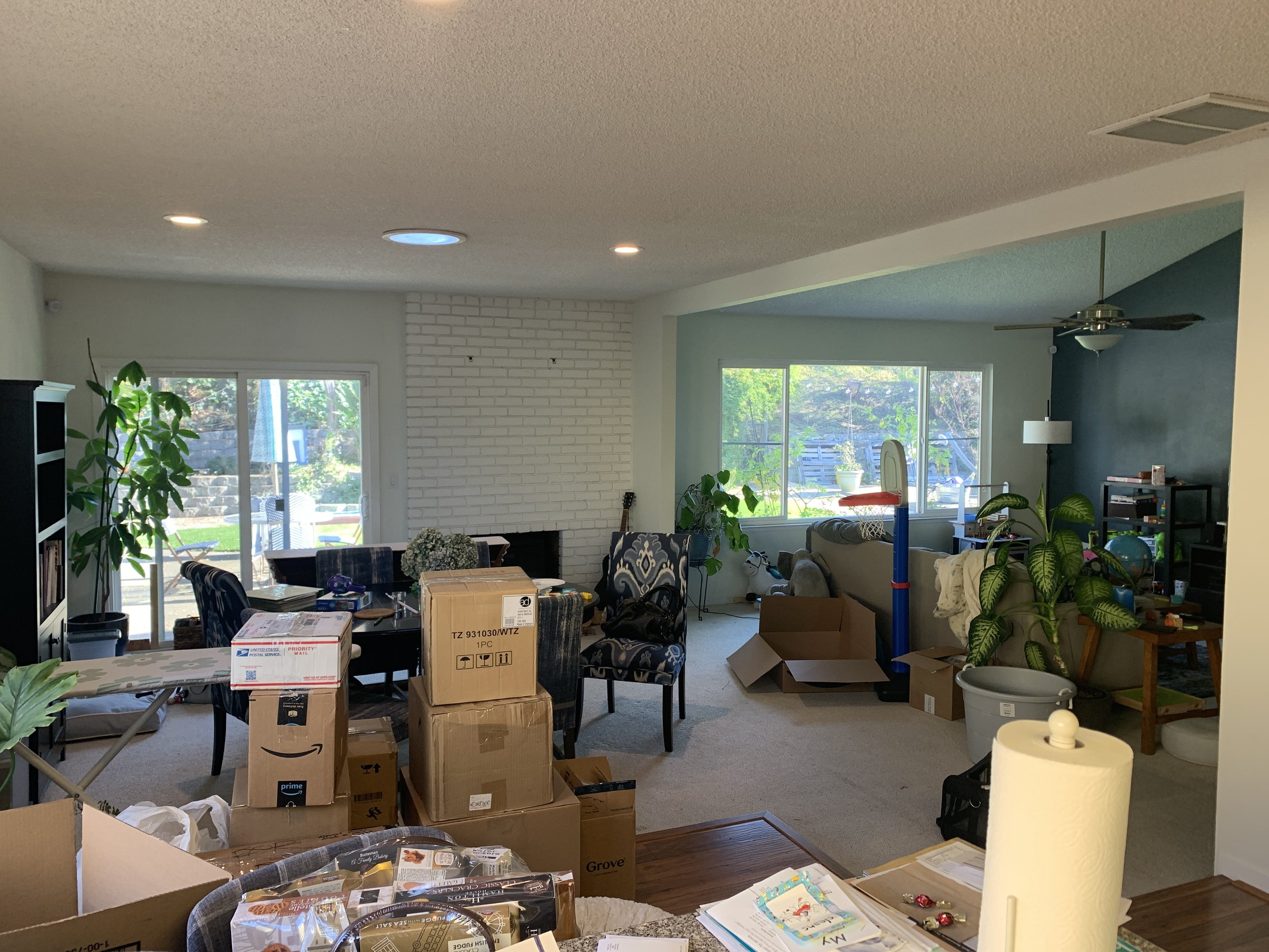 Living room and dining area before staging. Lots of boxes. Not a good look for real estate marketing. This needs Style it Staging for a Home staging make over.