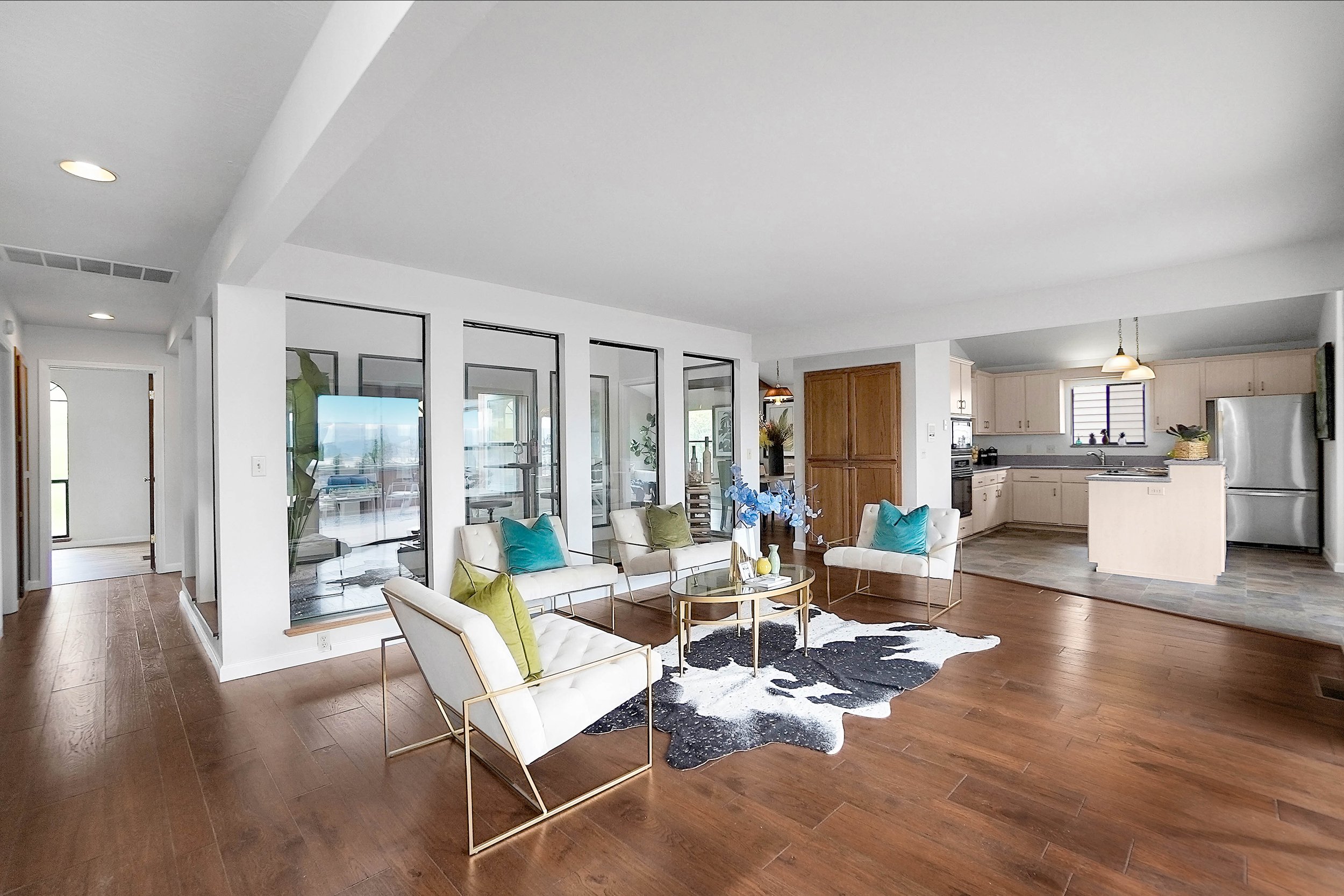 Styled living room with modern furnishings and cow hide rug. Style it Staging for real estate sales