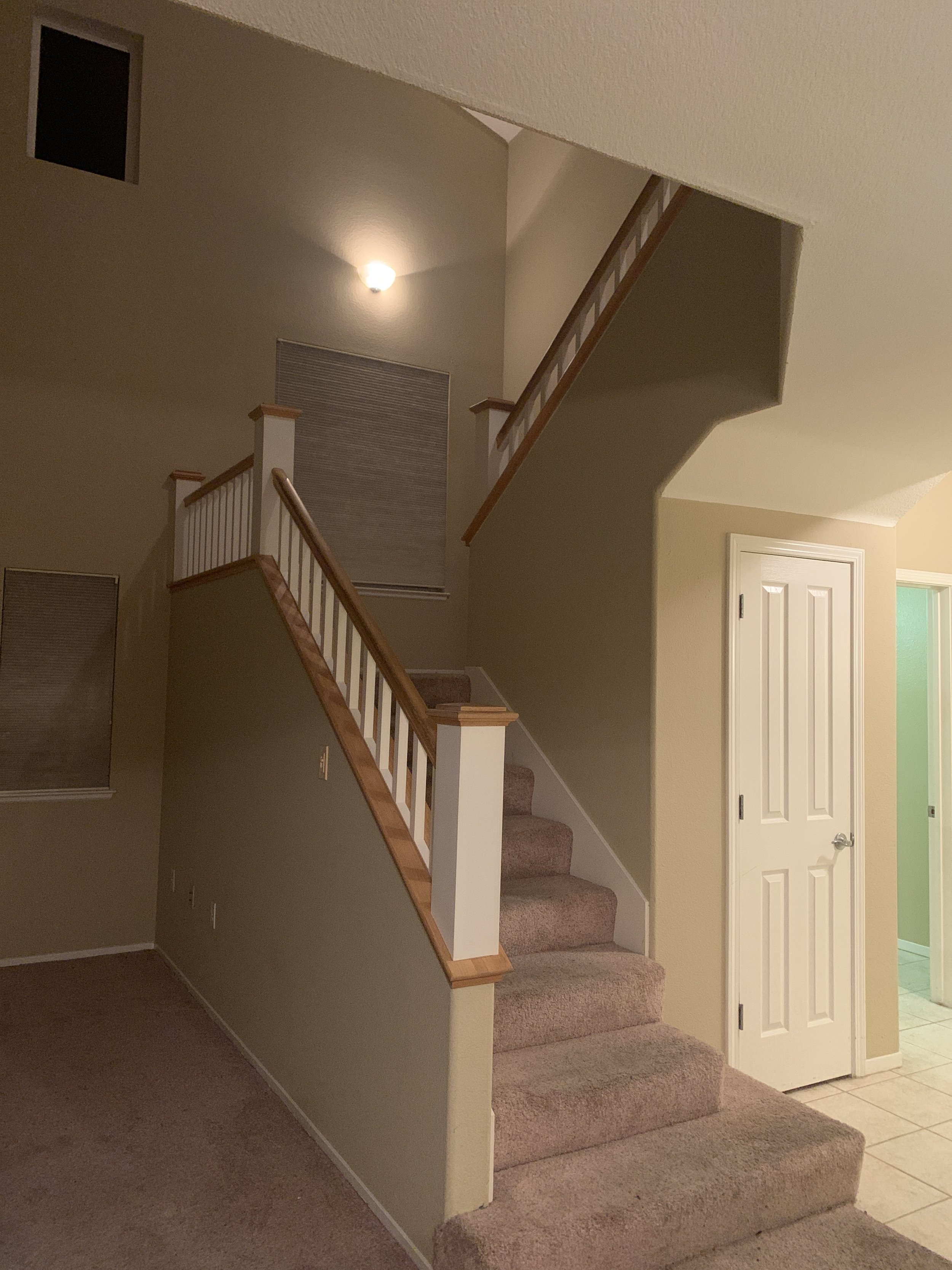 indoor stair case with light wood banister