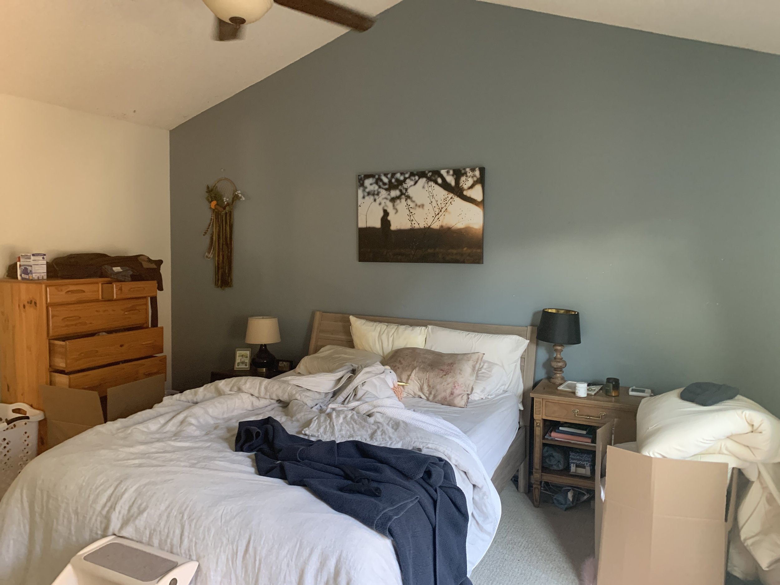 Mini make over bedroom. Before photo, messy bed, open drawers and green back wall.