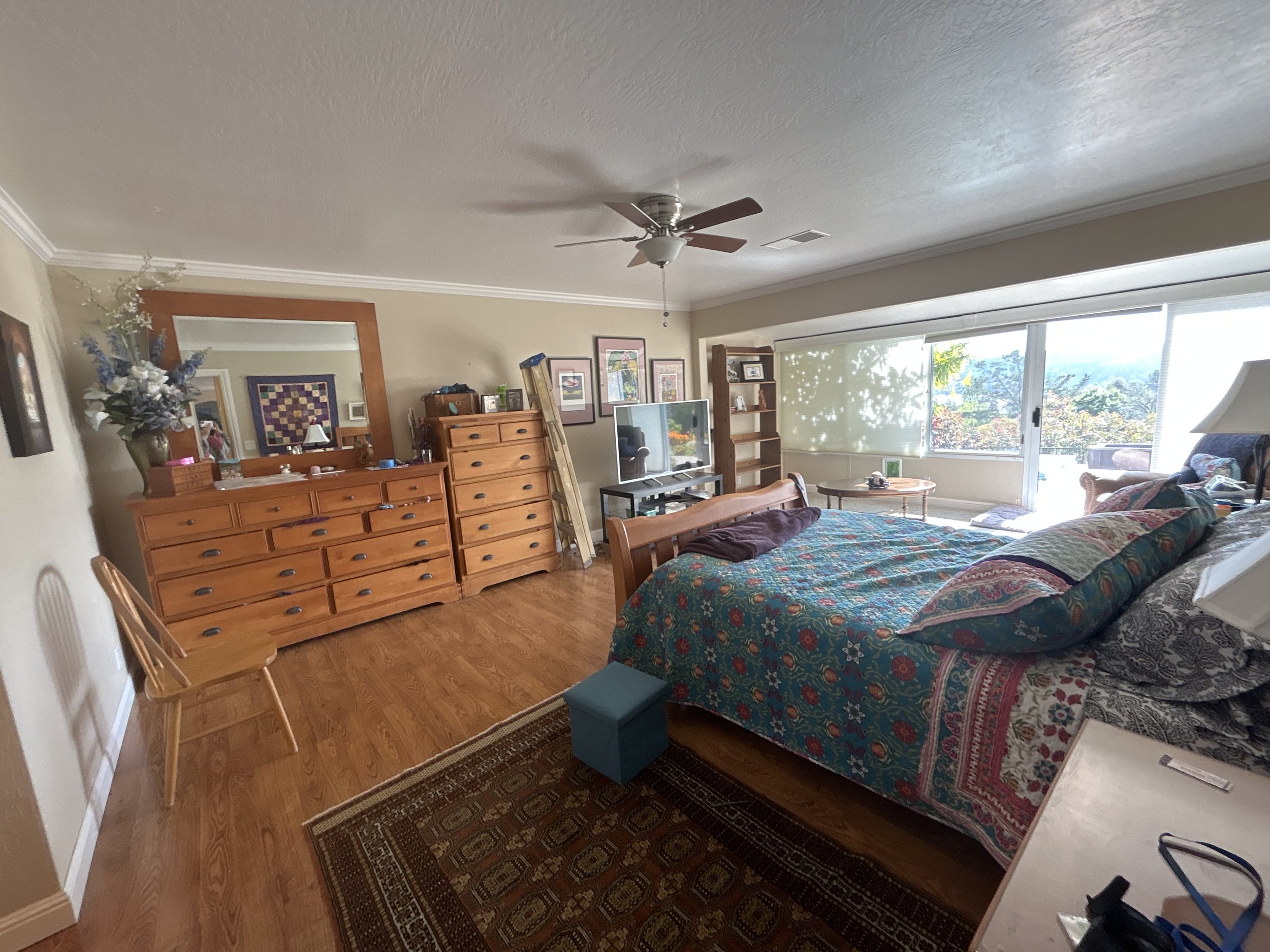 Too much furniture in this bedroom makes the room look cluttered. Home staging and interior design for home sales will help entice customers to buy.