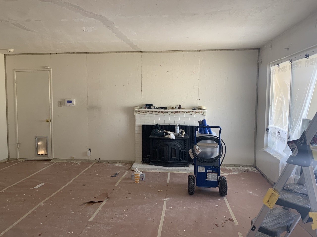 Before of a before and After of living room with fireplace. No furniture, prepped for painting