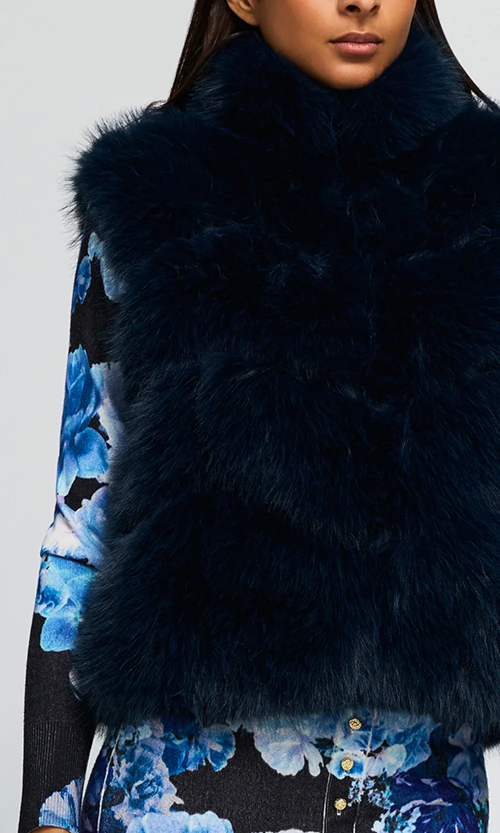 F26_RosarioFauxFurVest_Peacock_MiraFloralCardigan_PrimroseSkirt_NavyFleur3.1.webp
