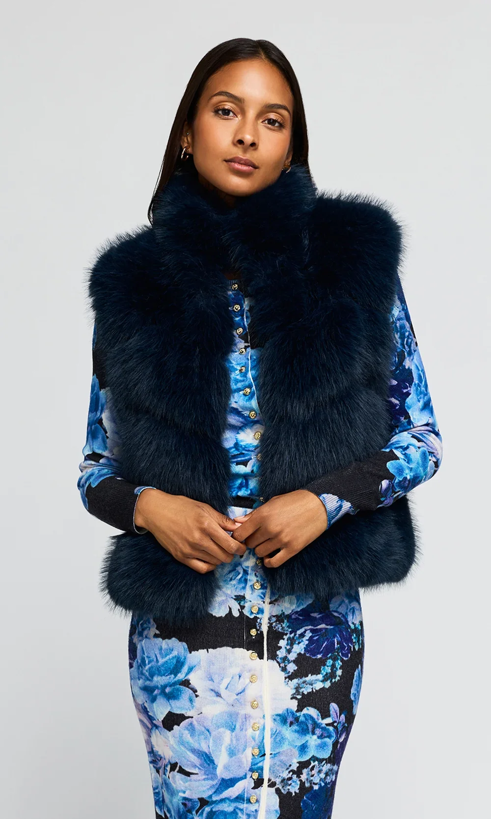 F26_RosarioFauxFurVest_Peacock_MiraFloralCardigan_PrimroseSkirt_NavyFleur1.1.webp