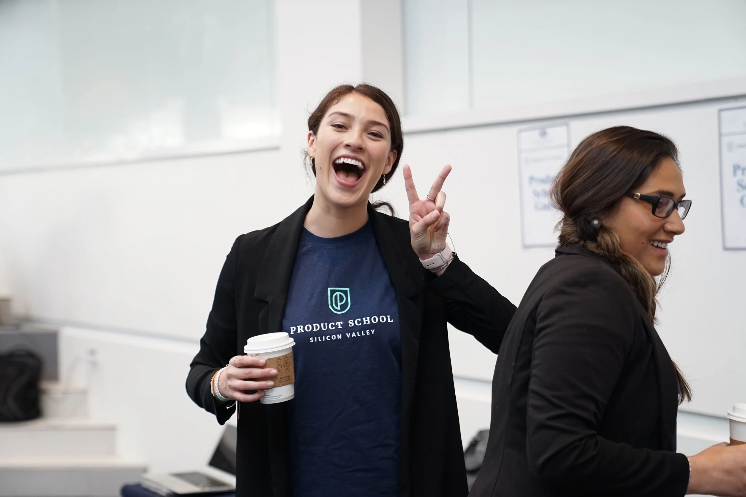 Student gives a peace smile with a big smile at a networking event.