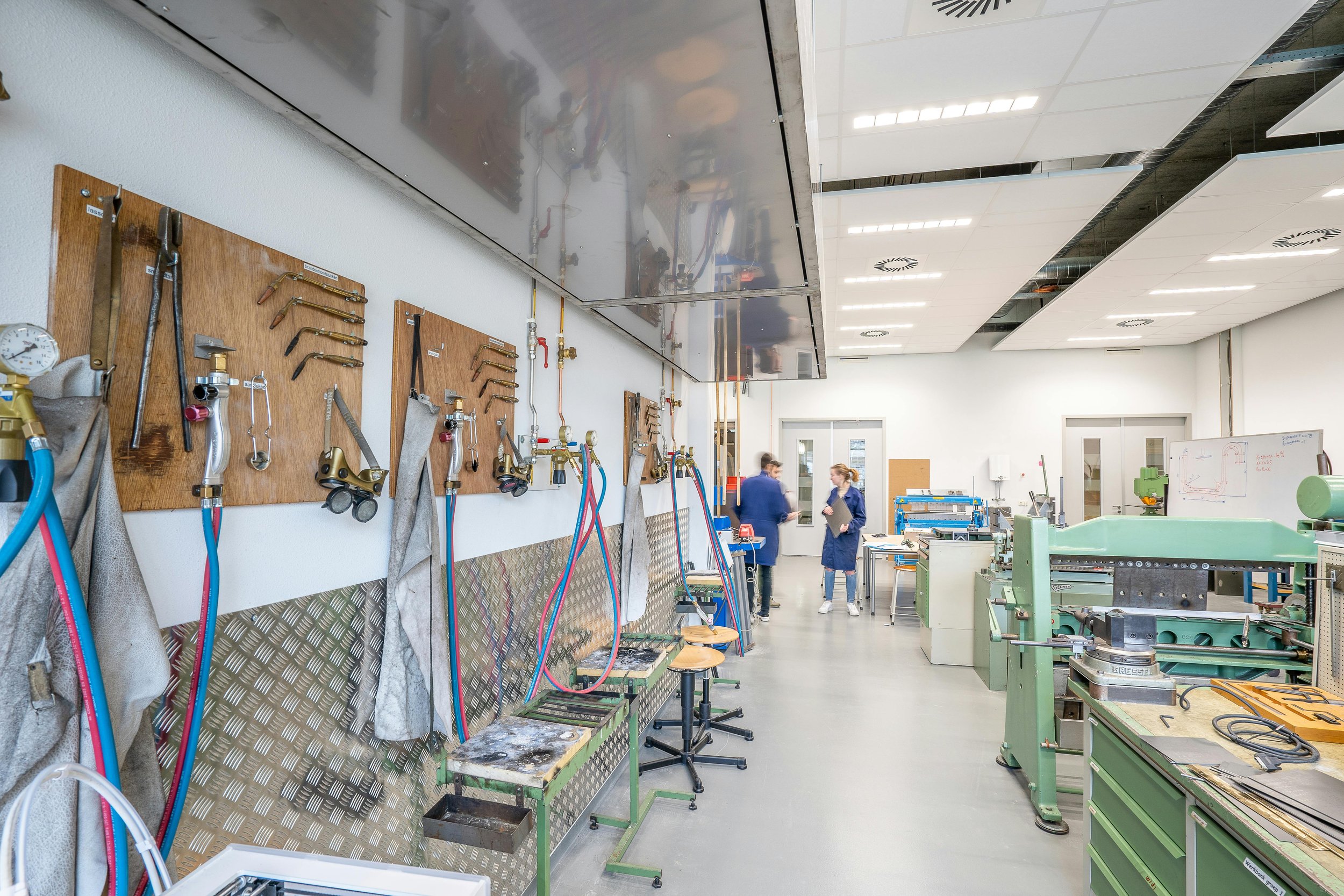 Teaching-focused engineering workshop with small lab stations and hands-on equipment at a small college
