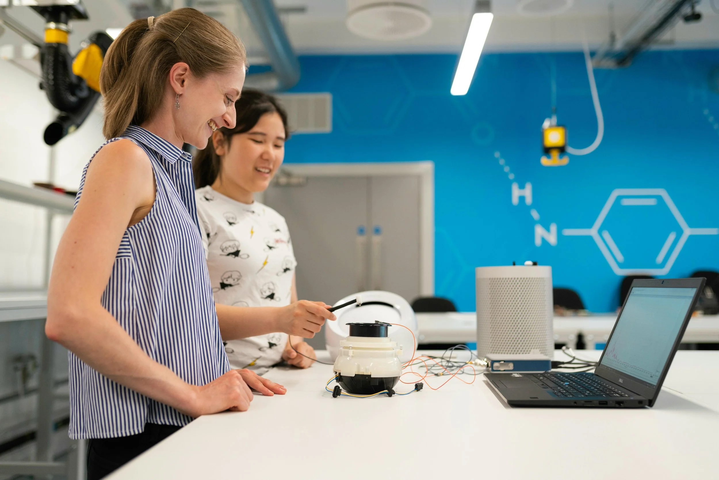Engineering student and faculty member testing and analyzing a small-scale prototype in an undergraduate teaching lab