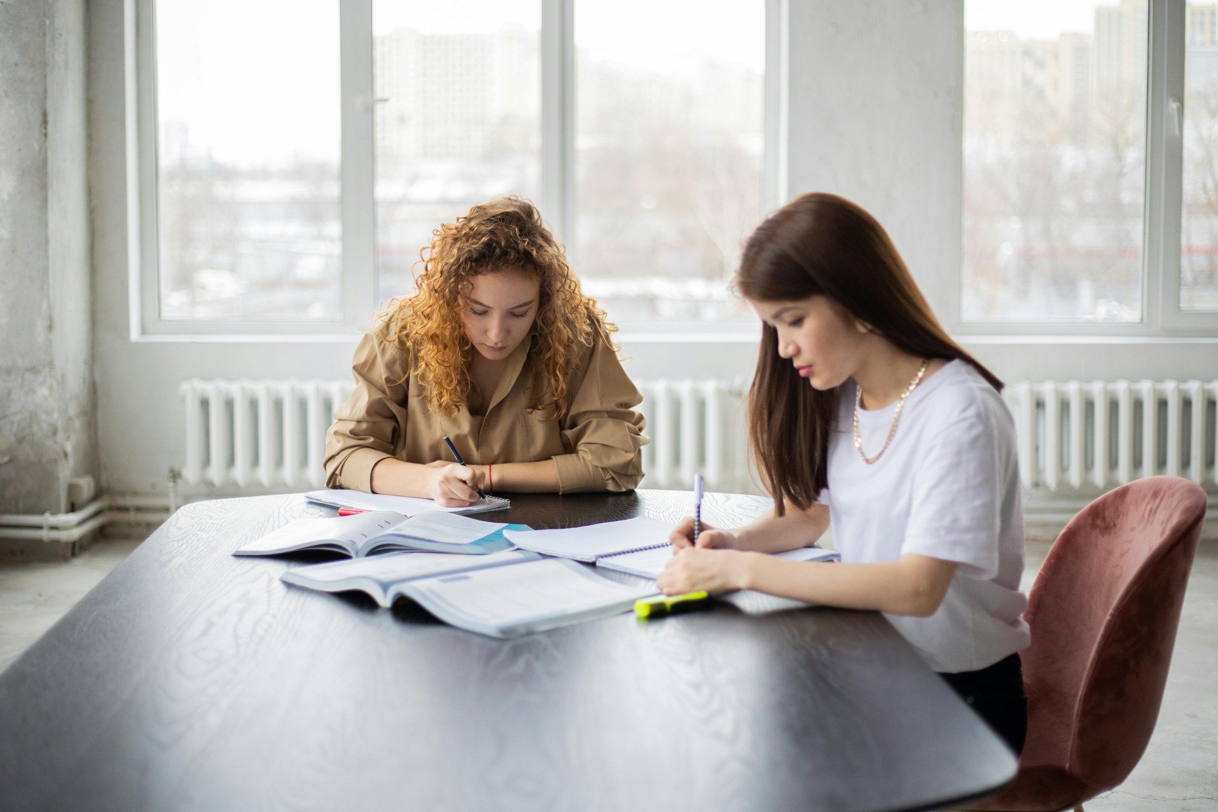 College students studying together at a large table, reflecting focused, rigorous academic work common in strong undergraduate engineering programs.