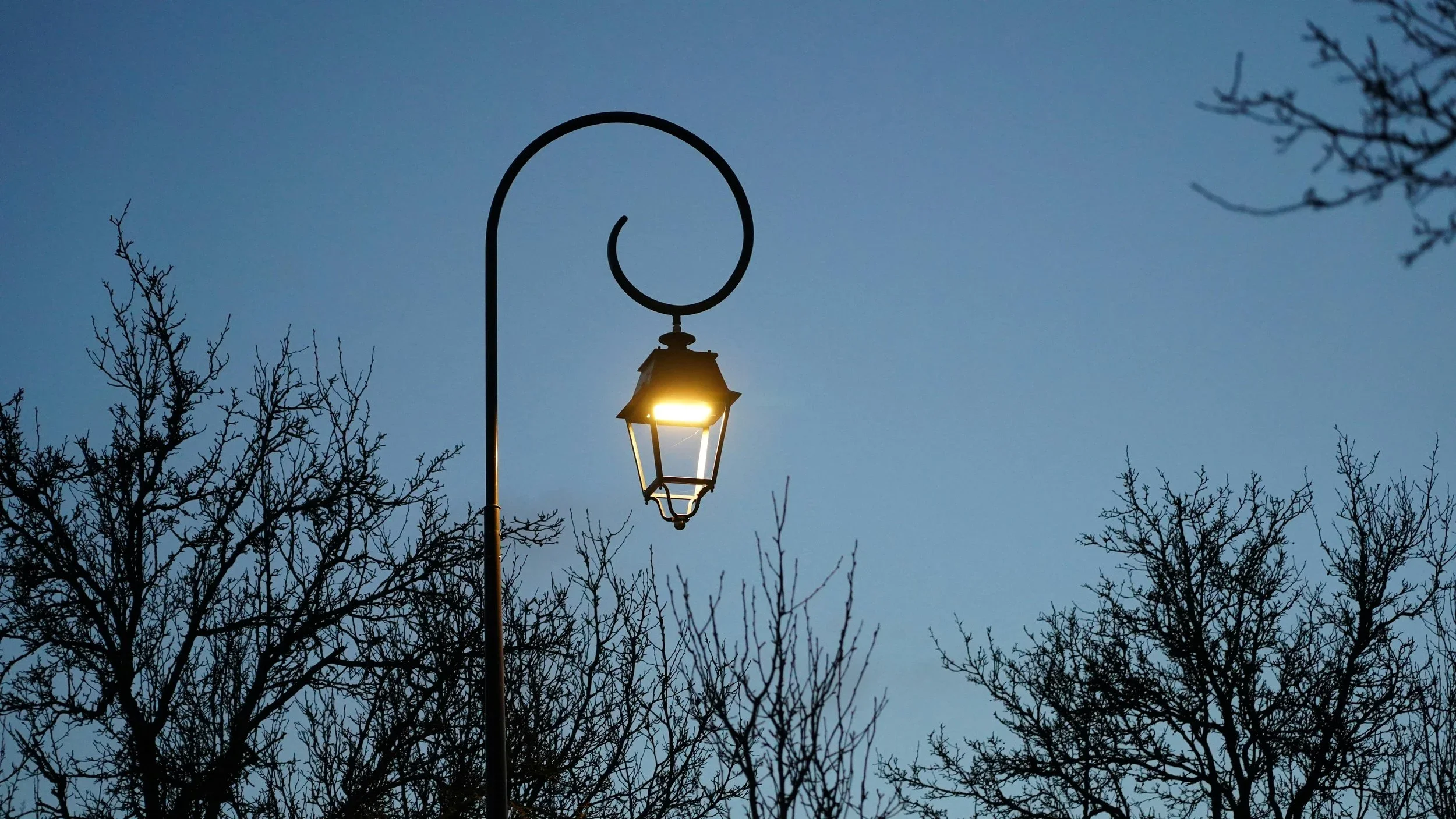 Illuminated lantern against a blue evening sky, symbolizing guidance and direction in the Deep-Fit Framework.