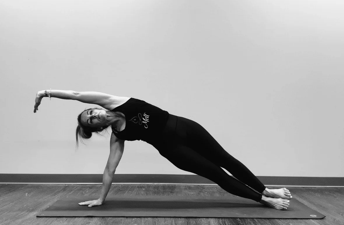 Shannon Tampa, Melt Pilates & Yoga studio owner performing the side plank Yoga pose.