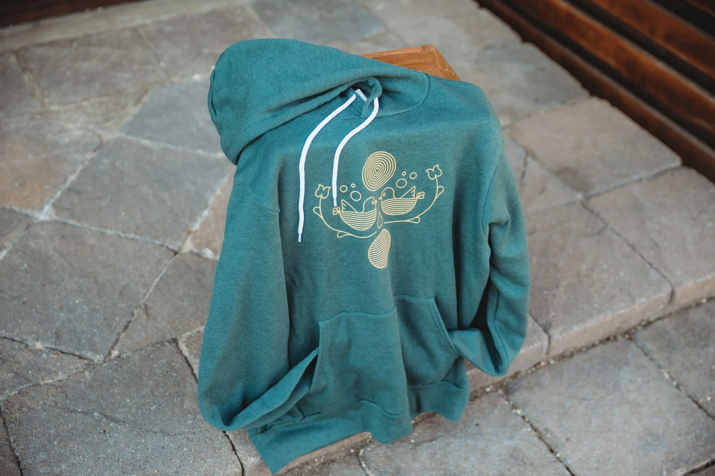 Front of Folk Artsy Hoodie propped up on apple box