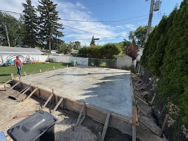 Concrete contractors pouring a driveway in Winnipeg, MB.