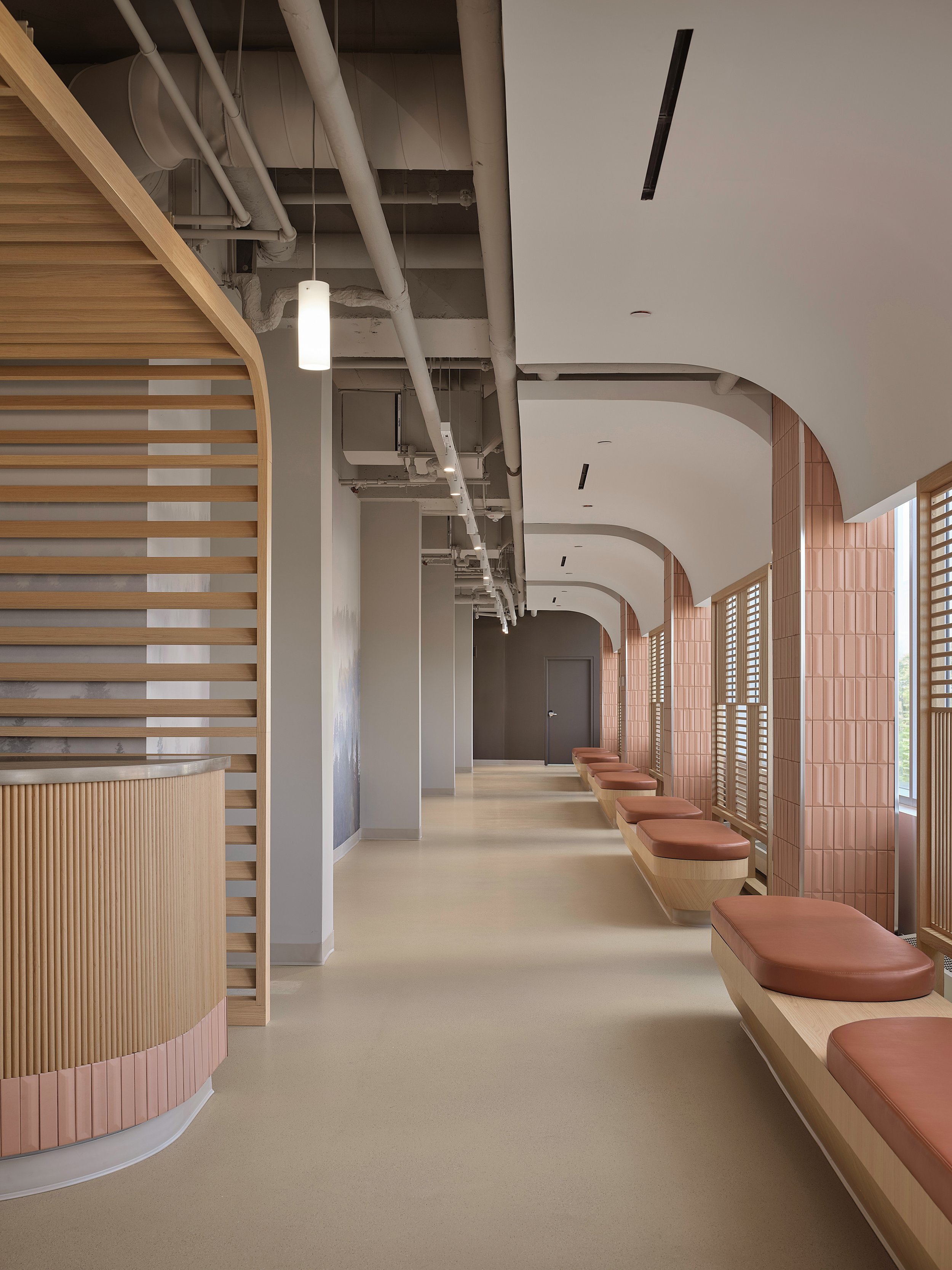A hallway lined with upholstered benches.