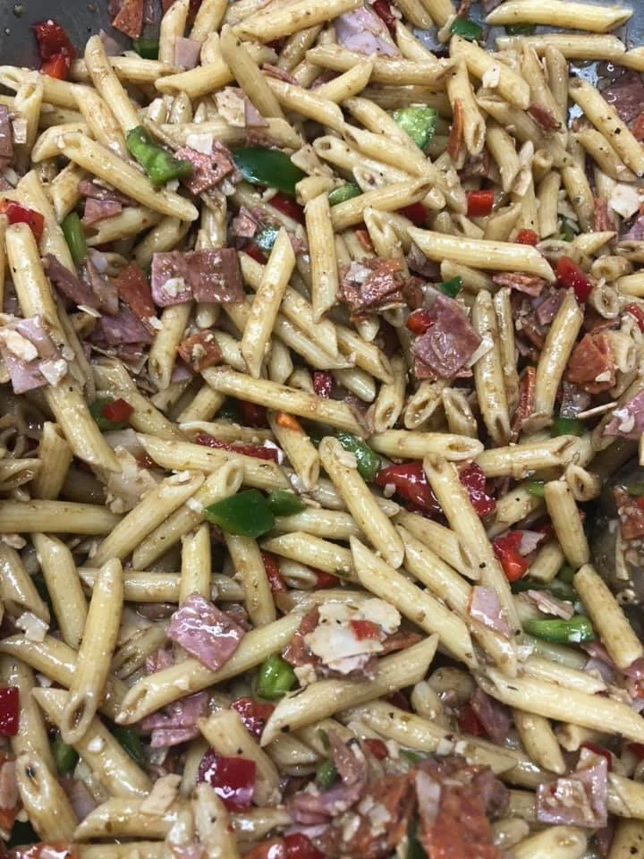 Pasta salad with penne pasta, chopped ham, red and green bell peppers
