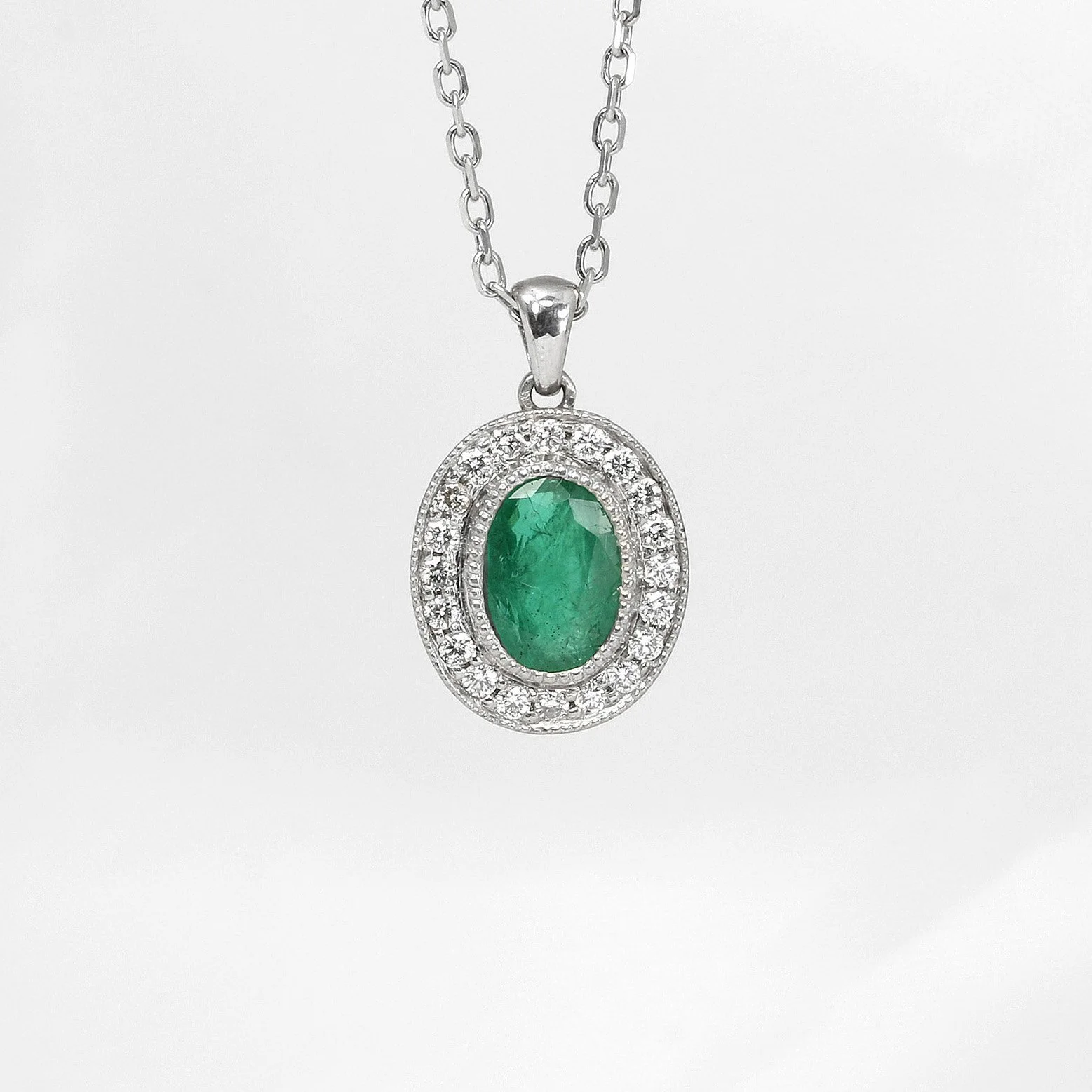  Timothy Roe Emerald and Diamond Halo Pendant in White Gold £1,120.00 