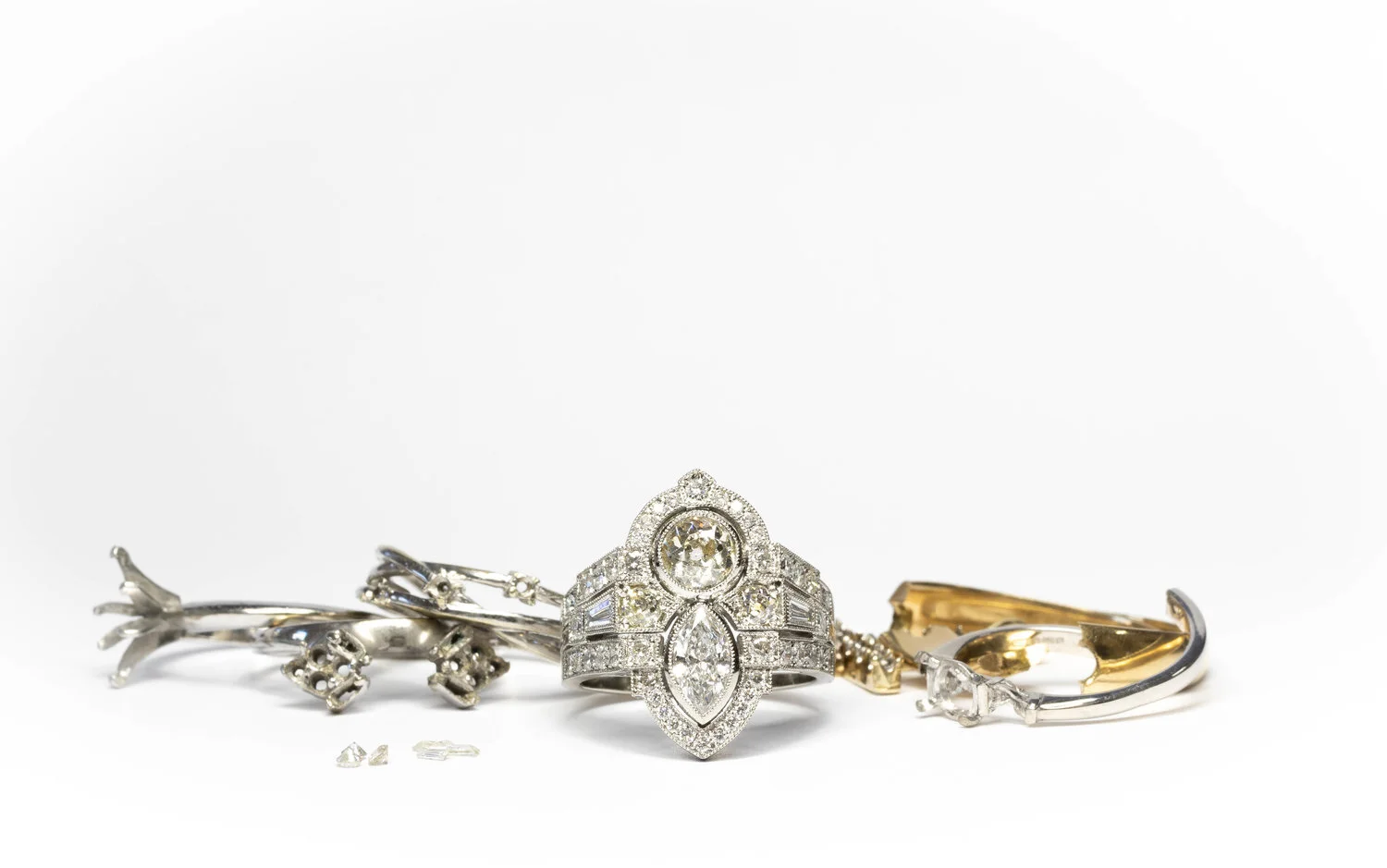  The completed ring amongst the old mounts from which the diamonds were removed. 