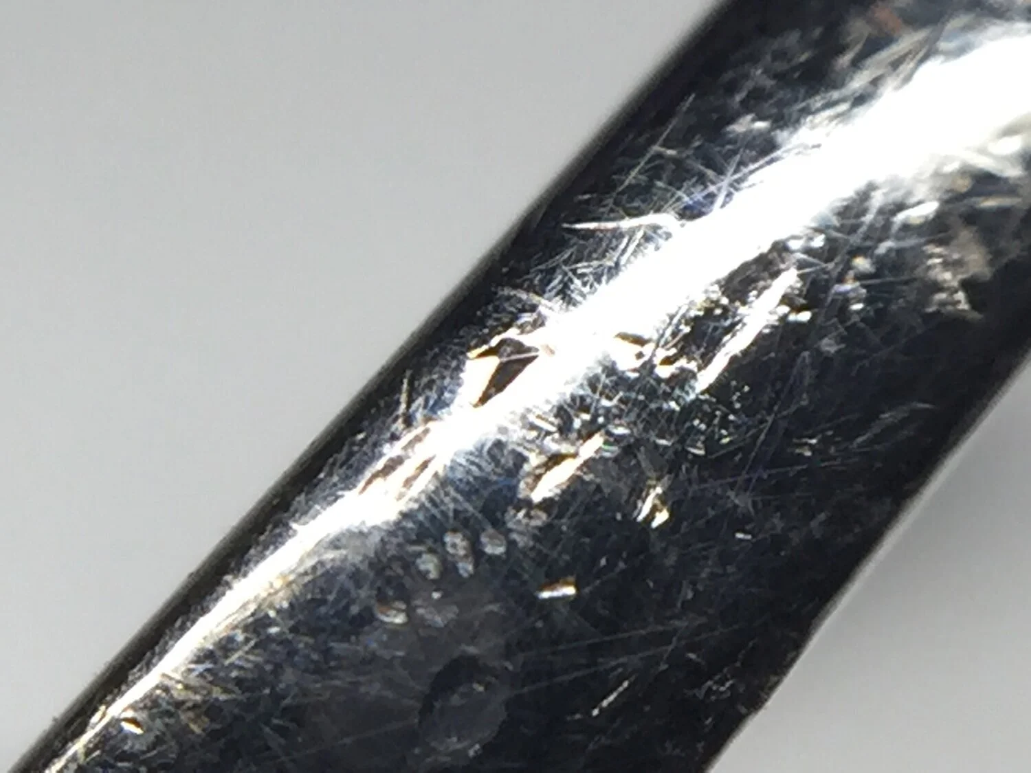  Image 9. Interesting impact marks with one showing the perfect shiny impression of the intersecting facets of a diamond from the ring that was doing the damage. 