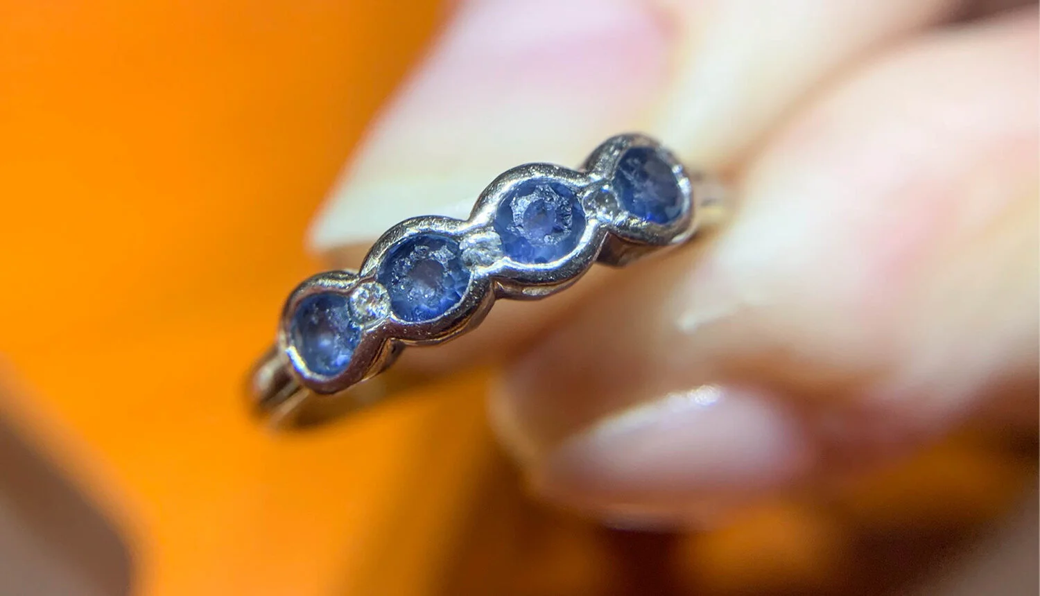  Image 11. This was a ring which we had made around 15 years previously. The centre diamond is broken and the sapphires have been worn and chipped with wear of some kind. This had happened over many years but it is not normal. In some cases, a cluster ring is sometimes worn resting on top of a slimmer eternity ring and I have seen the underneath of the central coloured stone, abraded by diamonds set into the eternity band. 