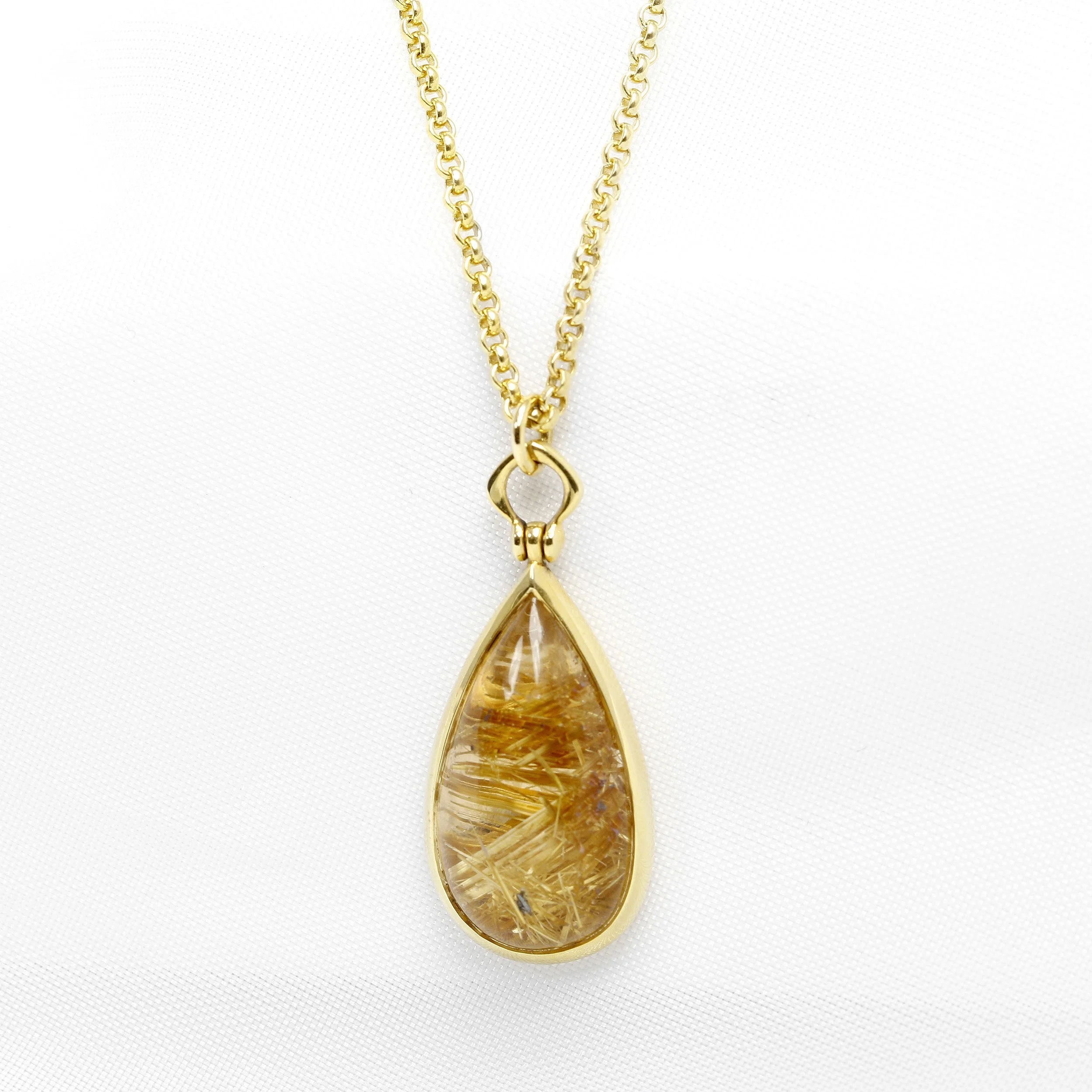  Timothy Roe Pear Shape Rutilated Quartz Pendant in 9ct Yellow Gold £930.00.  Golden rutile needles that have been encased in colourless quartz during formation look like shimmering strands of gold threads when they hit the light—a truly beautiful phenomenon.  