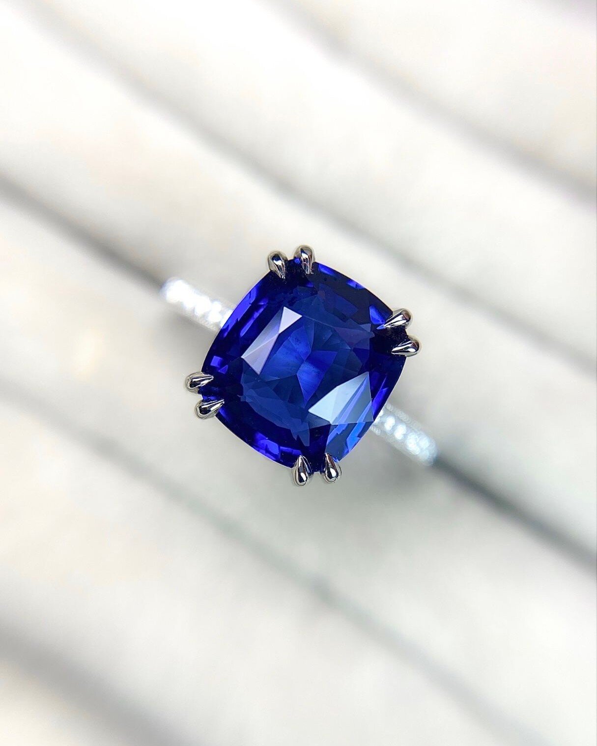 I know what you're thinking... You thought you knew what blue was until you saw this sapphire. 

This sapphire and diamond ring has been set in platinum, the central cushion cut sapphire is an astonishing weight of 4.58ct in weight! If you would like
