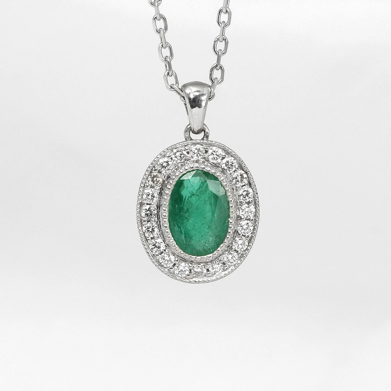  Emerald and Diamond Halo Pendant in 9ct White Gold £1,120.00 