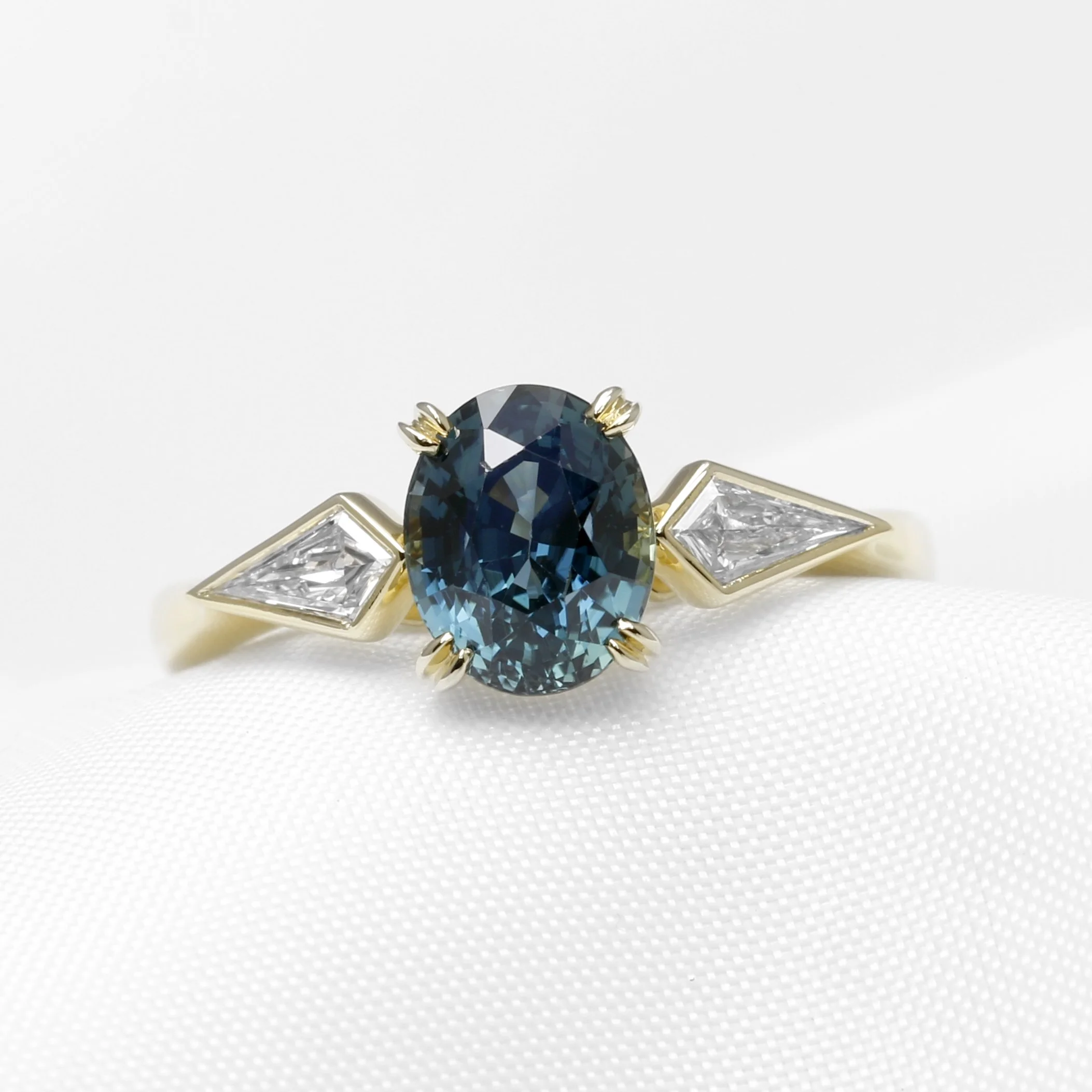  Bespoke Commission: Contemporary Style Engagement Ring in 18 ct Yellow Gold with Kite Diamonds and an Oval Mixed Cut Teal Sapphire Completed 2024 