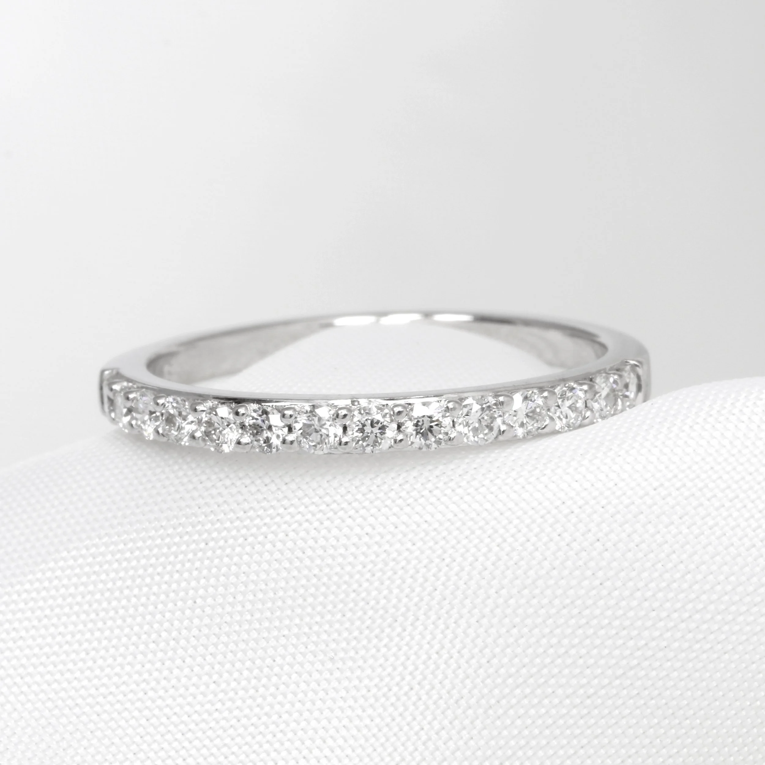  The same white gold half eternity ring after professional cleaning, polishing and rhodium plating 