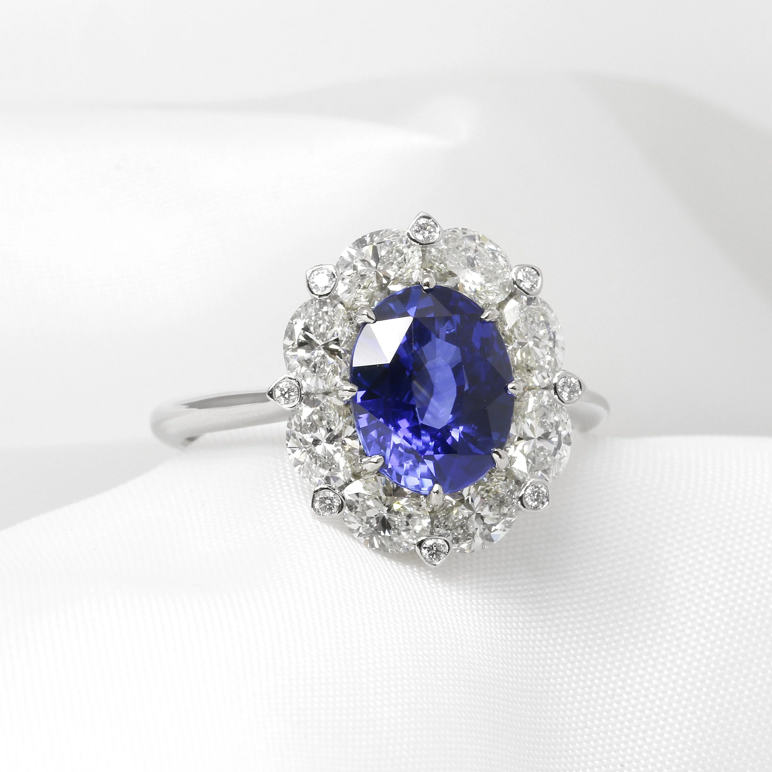 Oval Sapphire and Diamond Bordered Cluster Ring in Platinum