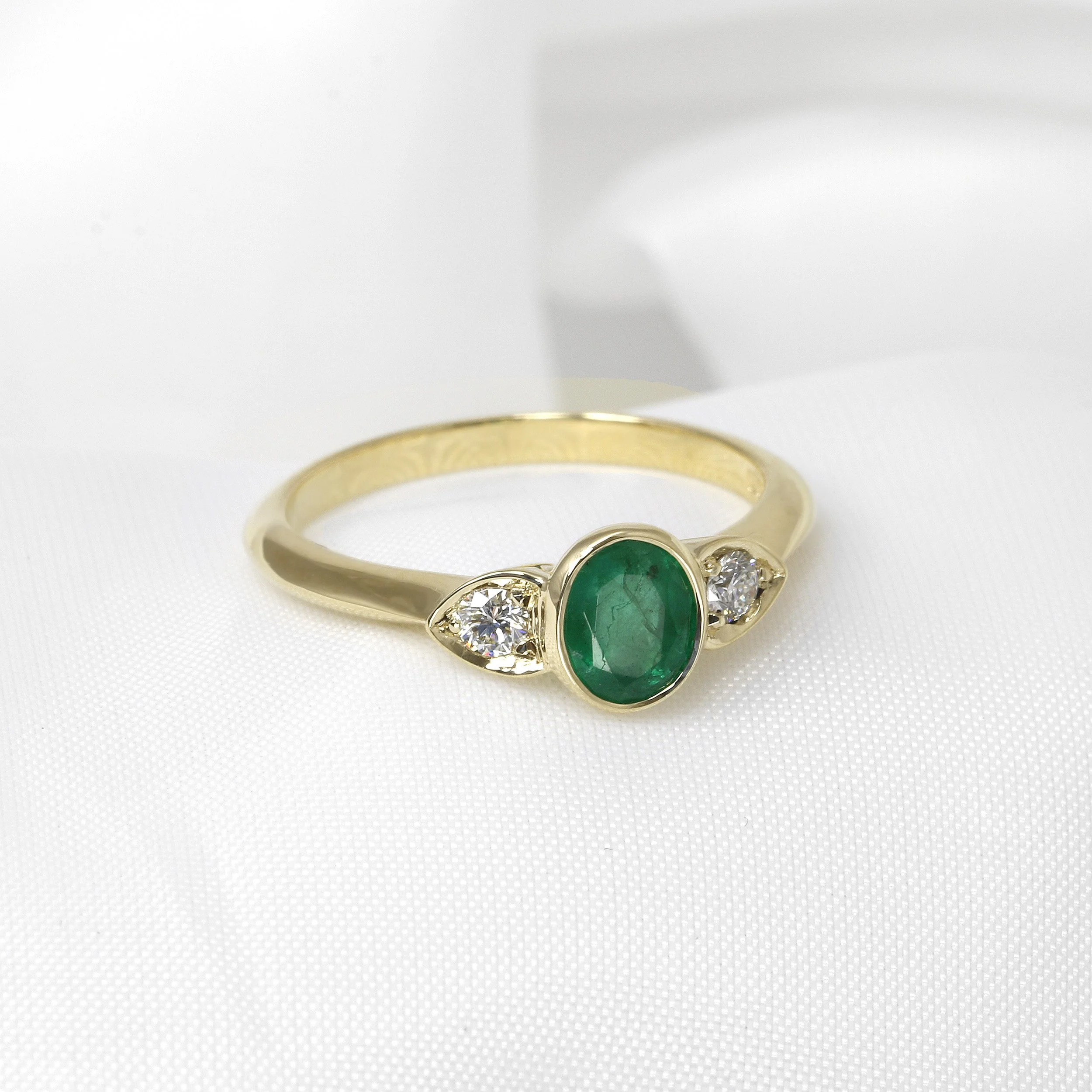 Oval Emerald and Diamond Three Stone Ring in Yellow Gold