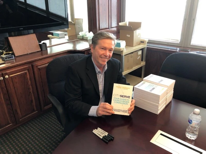 Dave signing books at CityServe release