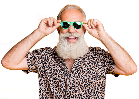 Smiling man with a gray beard and hair wearing a leopard print shirt and green sunglasses, holding the sunglasses with both hands, against a bright yellow background.