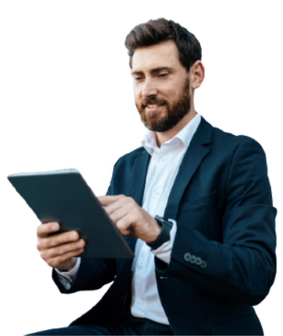 A man in a business suit looking at a tablet device