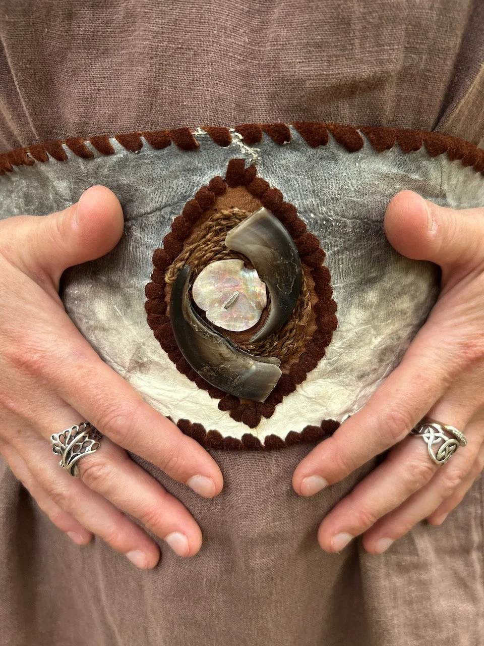 Sarah West artist handcrafted fishskin belt and bear claws.jpeg