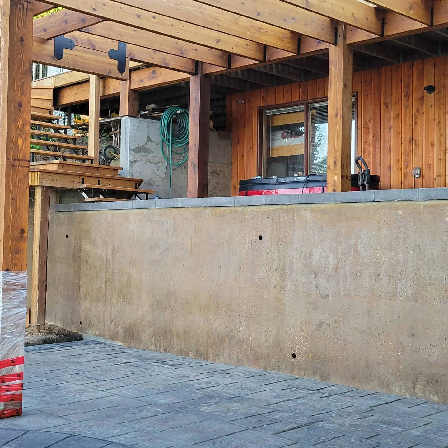 Dave's latest project.  Custom cedar pergola, structural Retaining wall, cedar stairs, glass railing and dyed stamped concrete. Crystal Springs #Pigeon Lake.  #stampedconcrete #pergola #decks #retainingwalls #foundations #hbs #HBSfoundations
