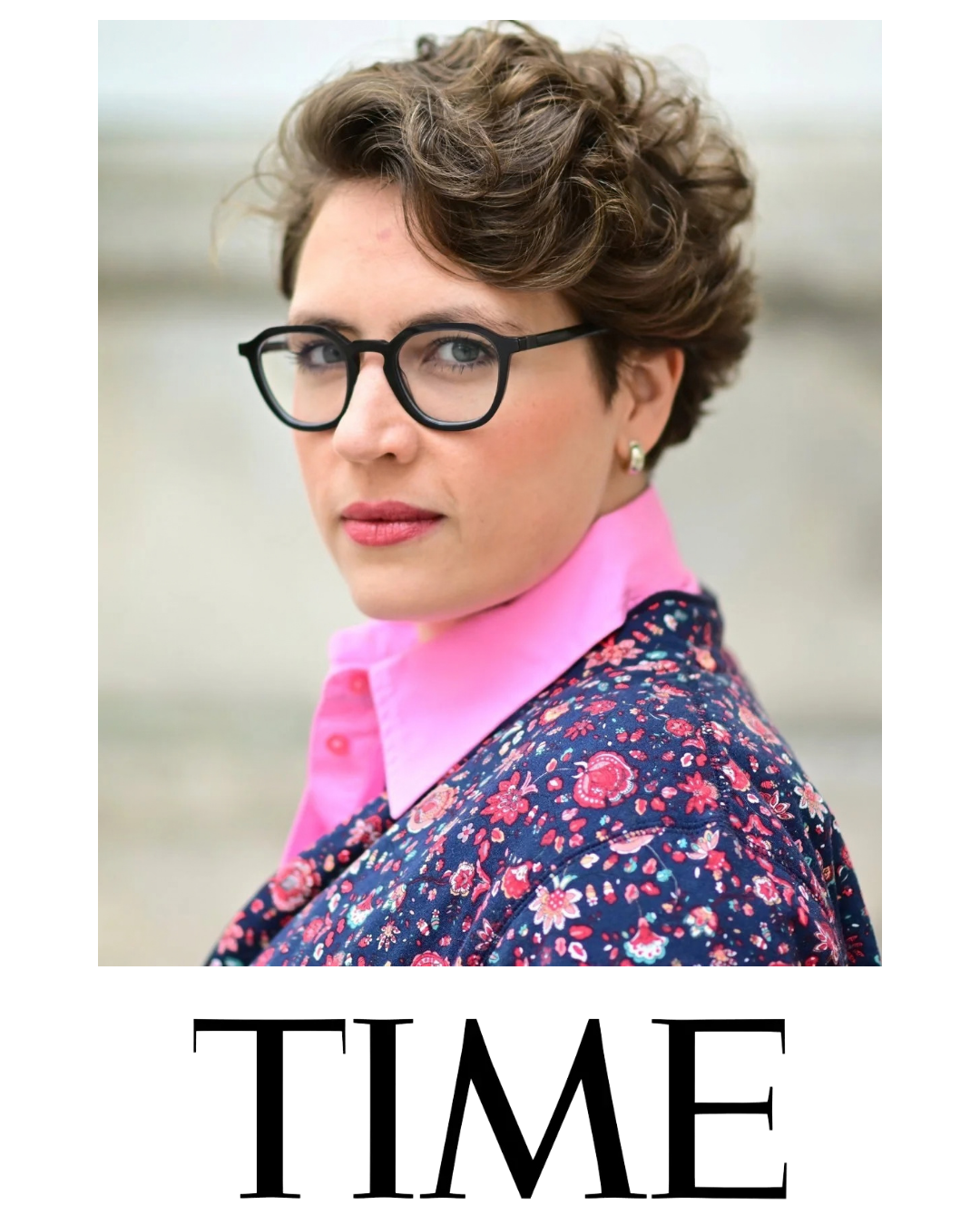 A woman with short, curly brown hair, wearing black glasses, a pink collared shirt, and a floral jacket, looking over her shoulder. The word "TIME" appears below the image.