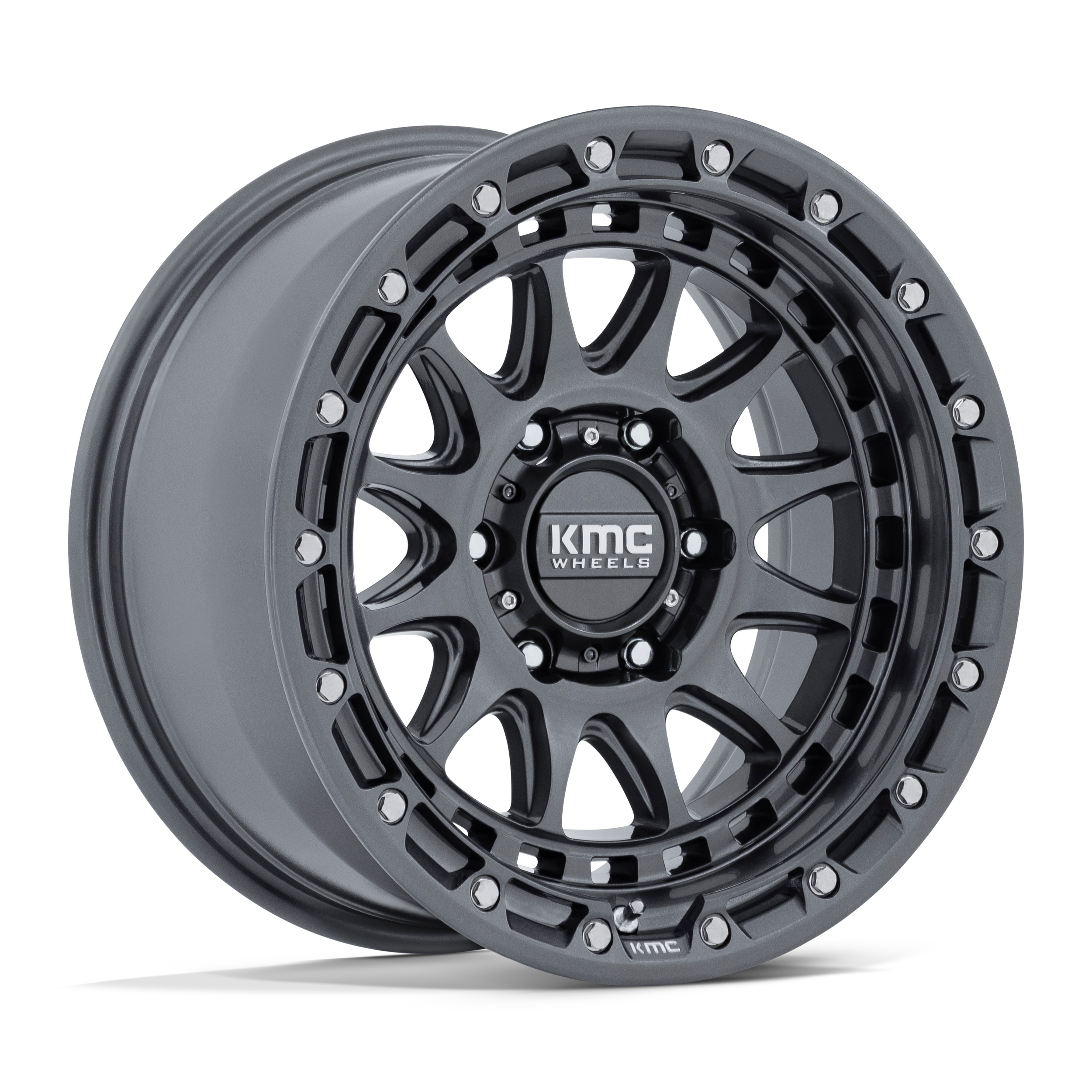 Black KMC off-road vehicle wheel with multiple holes and bolts, displayed against a black background.