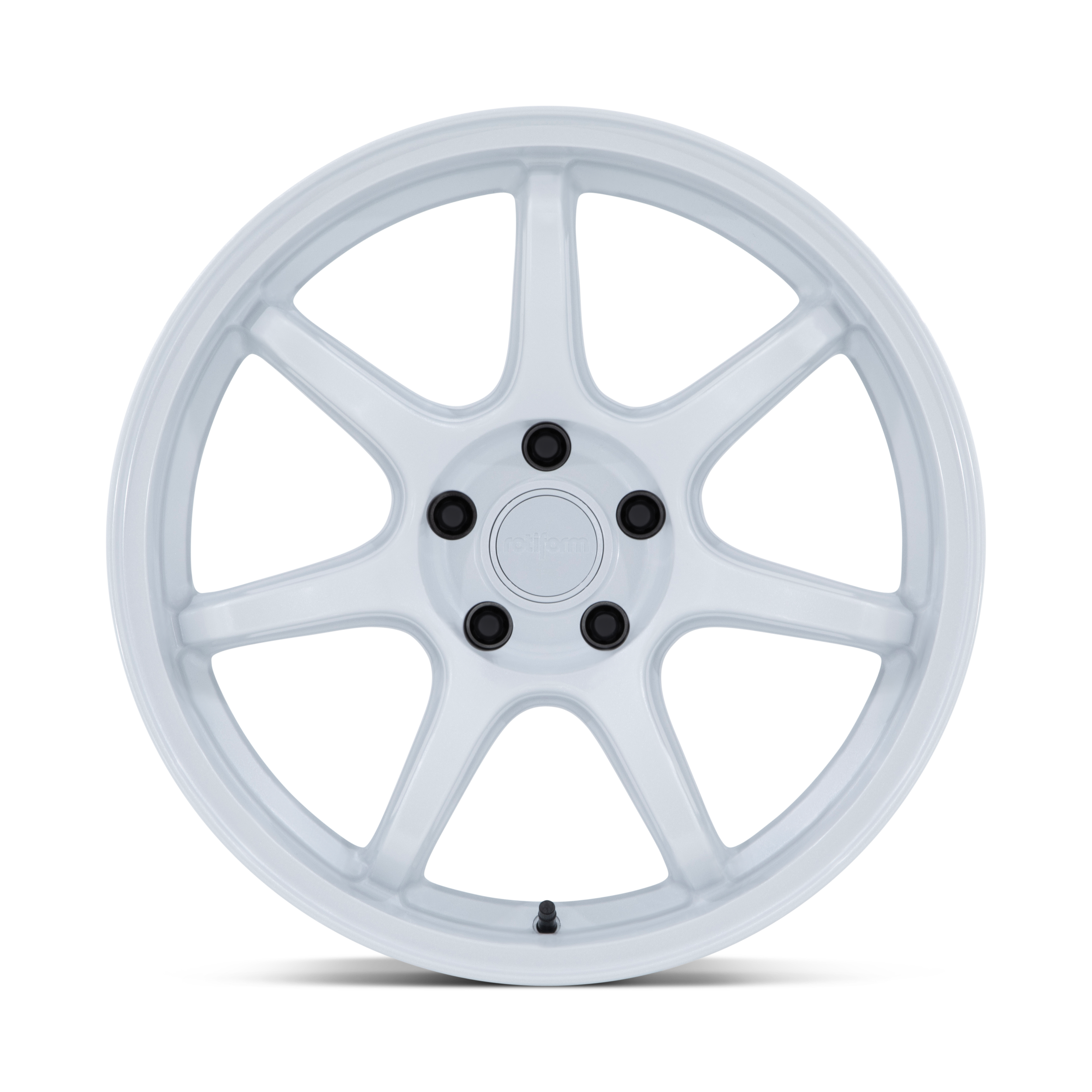 A white multi-spoke wheel rim with black lug nut covers and a valve stem.