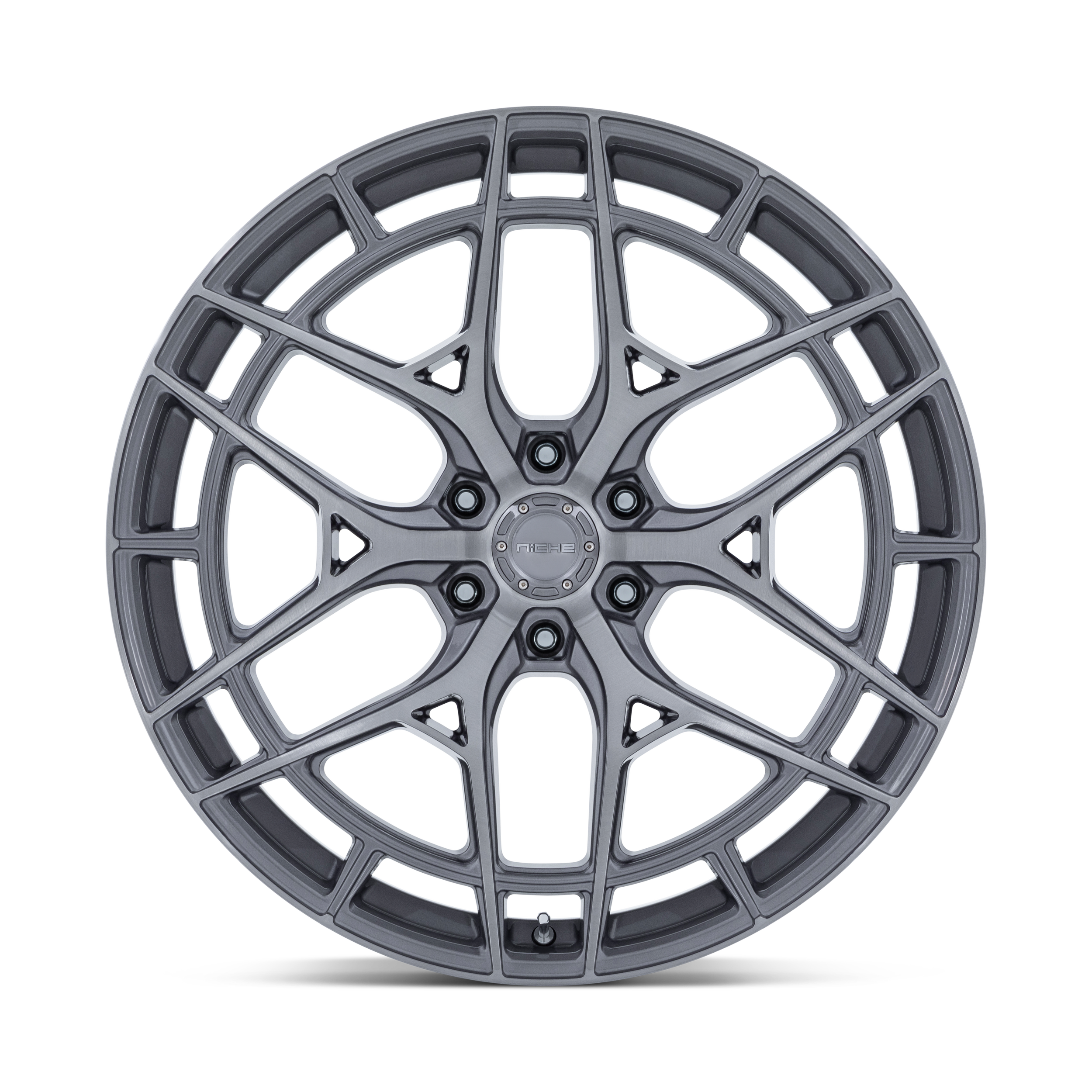 A silver alloy car wheel rim with intricate spoke design isolated against a black background.
