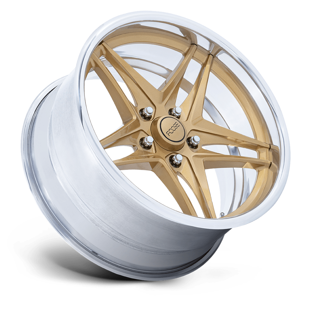 A gold and silver car wheel rim with a central hub that has the brand name 'FOOSE' engraved on it.