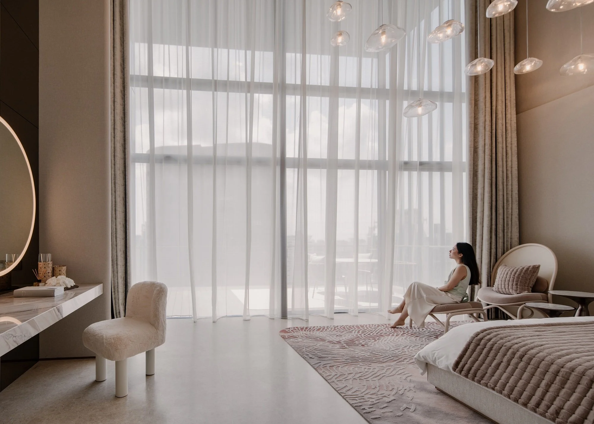 A woman enjoys her time in the master bedroom